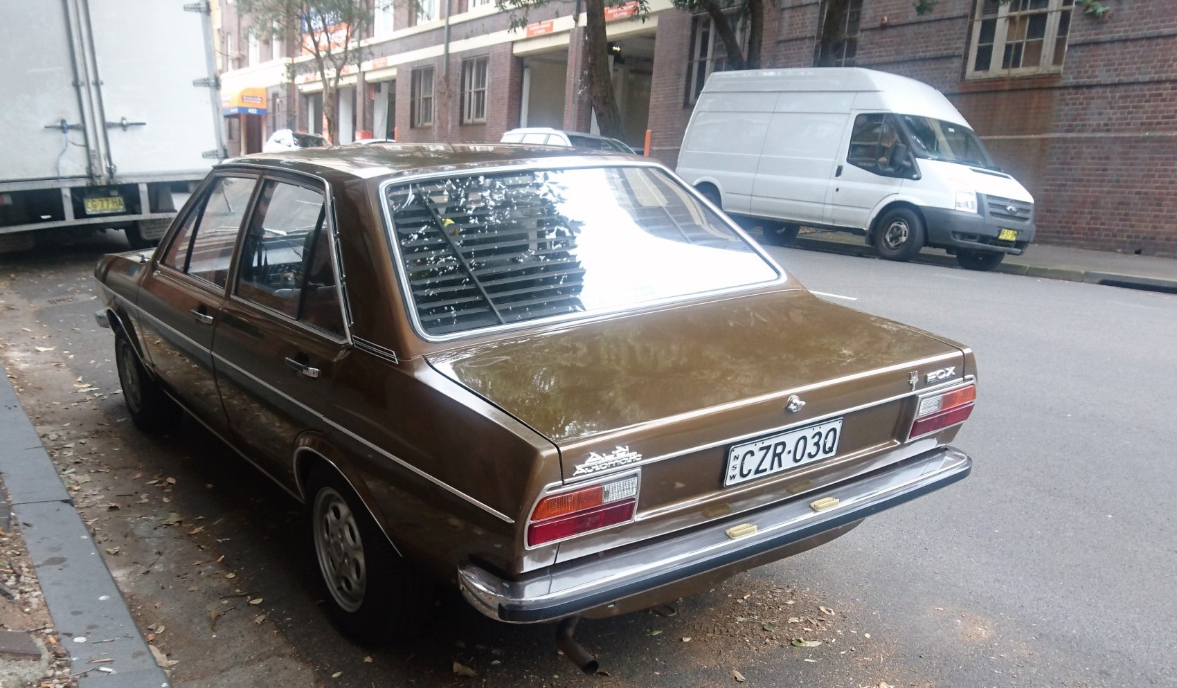Vintage 1970s sedan rear with chrome bumper and classic taillights