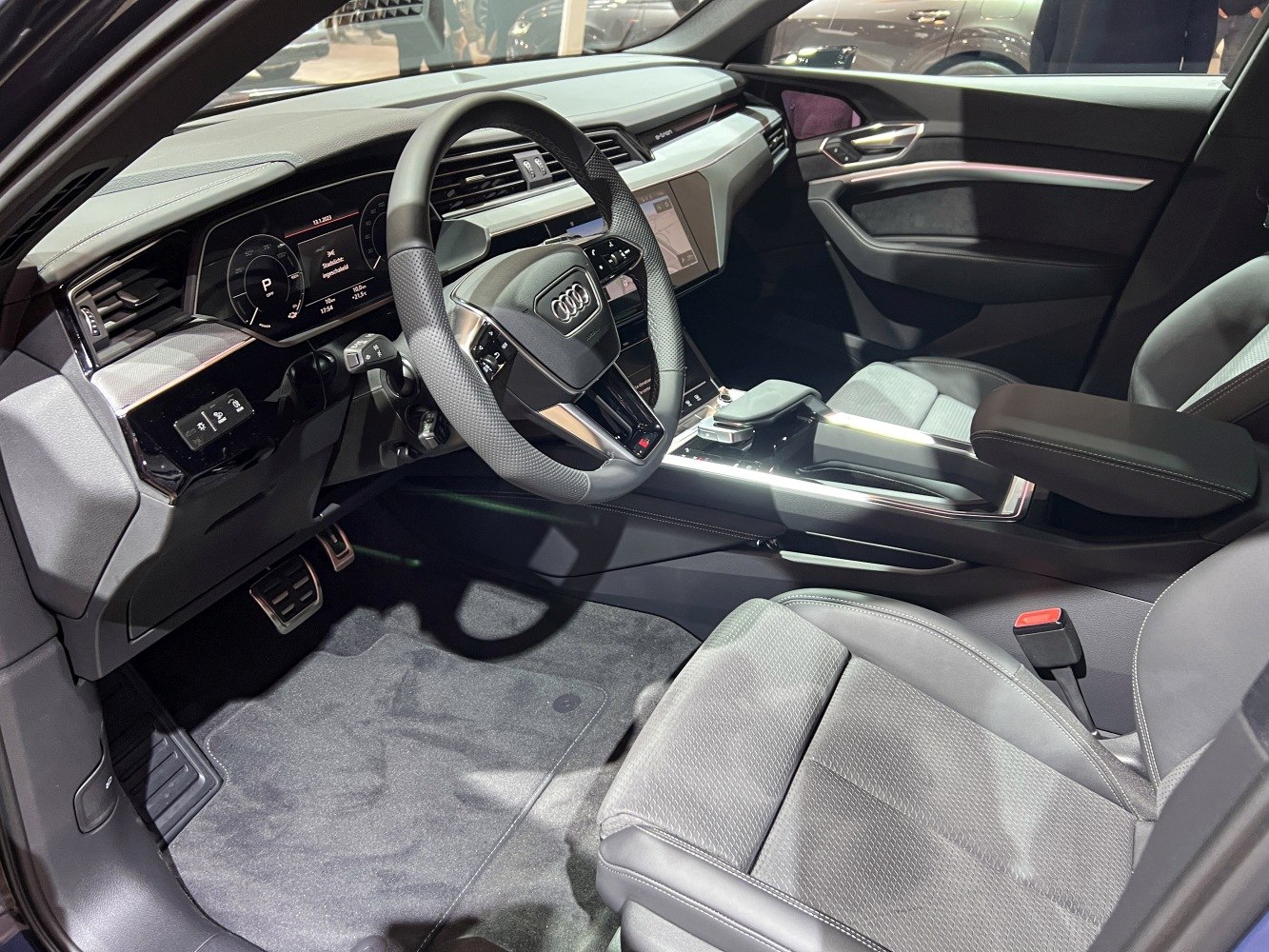 Luxury car interior with advanced dashboard and multi-function steering wheel