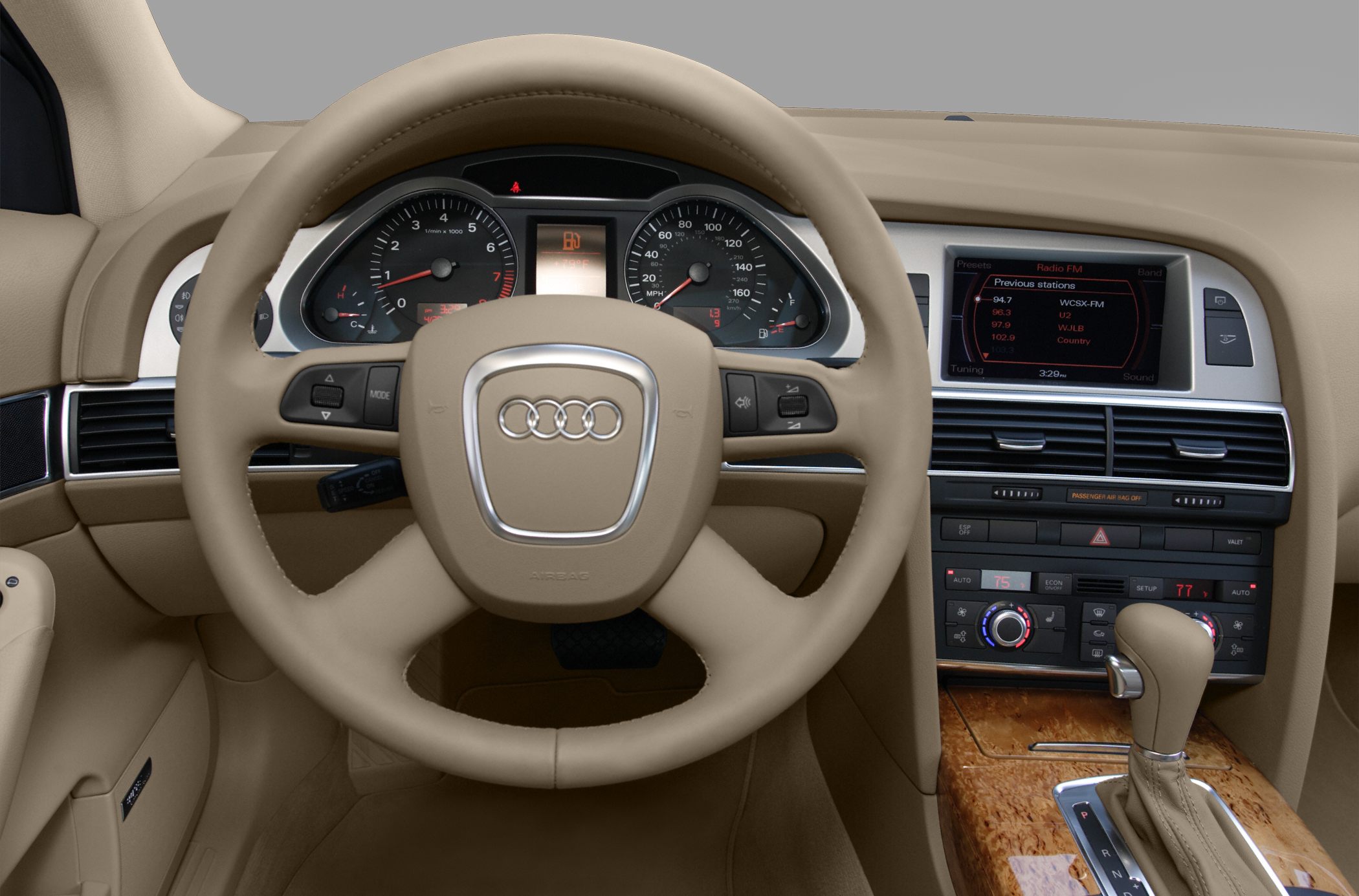 Beige luxury interior with steering wheel, dashboard, and multimedia screen