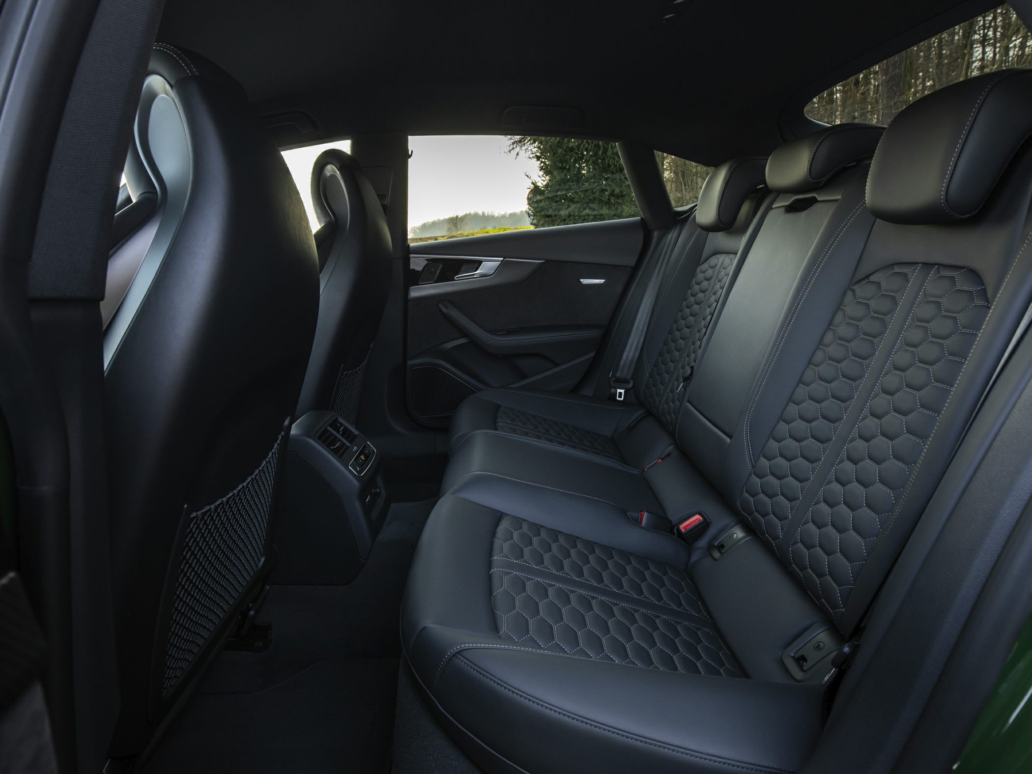 Luxurious rear seats with detailed hexagonal stitching and spacious design