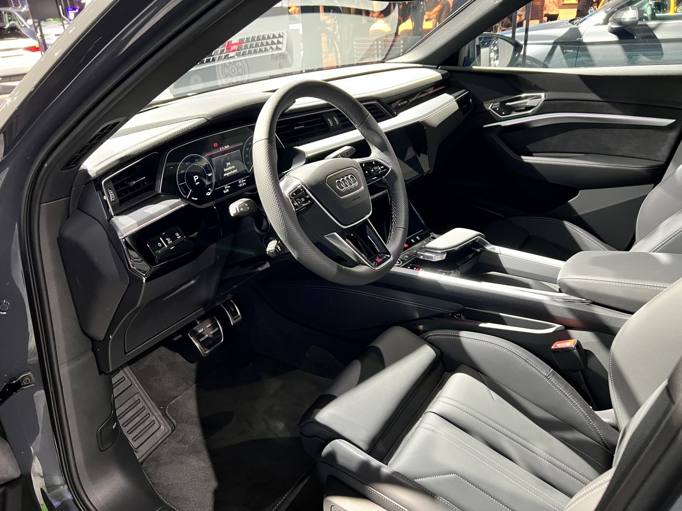 Digital dashboard and leather steering wheel in modern SUV interior