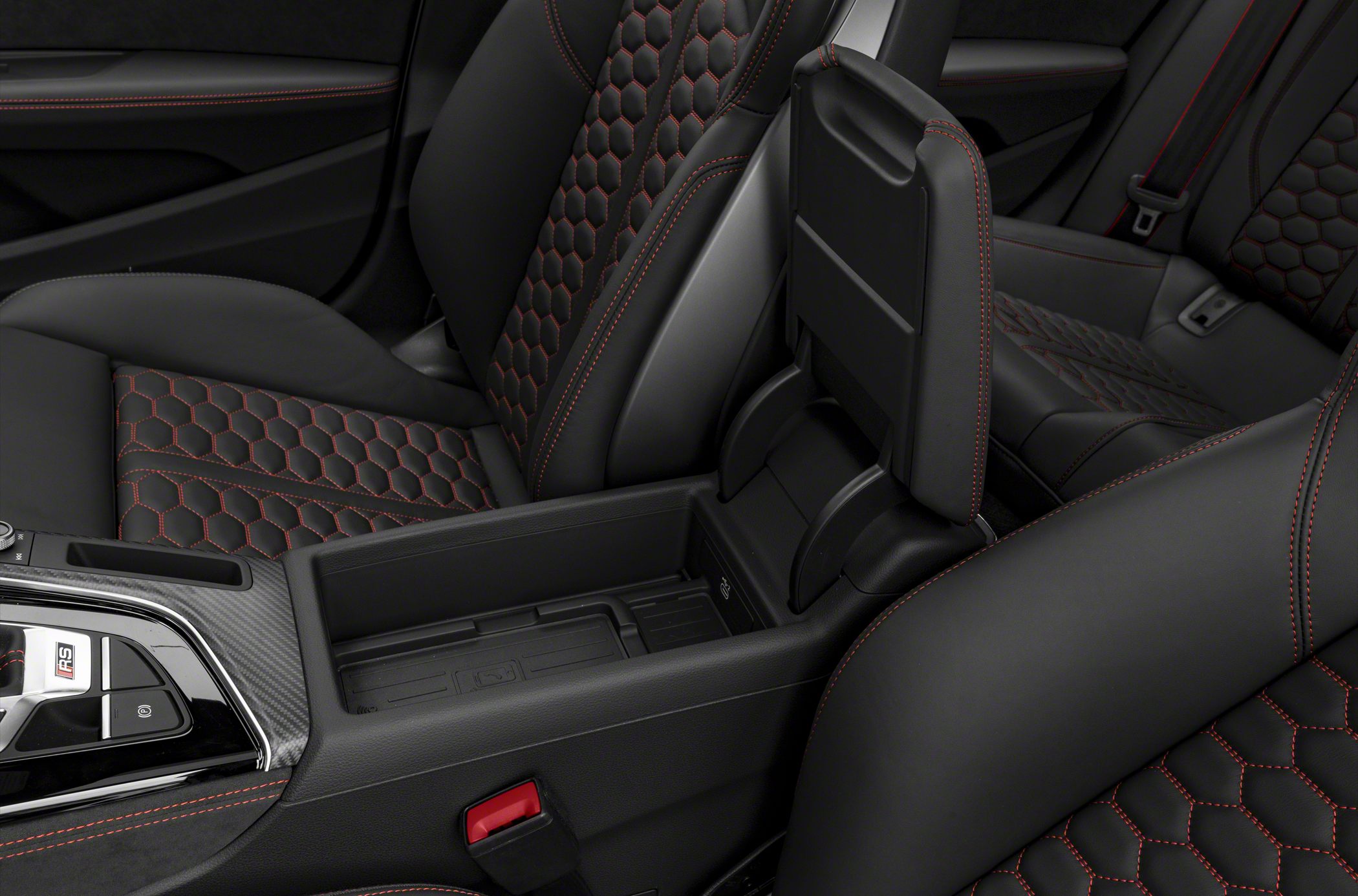 Black leather car seats with red hexagonal stitching and center console