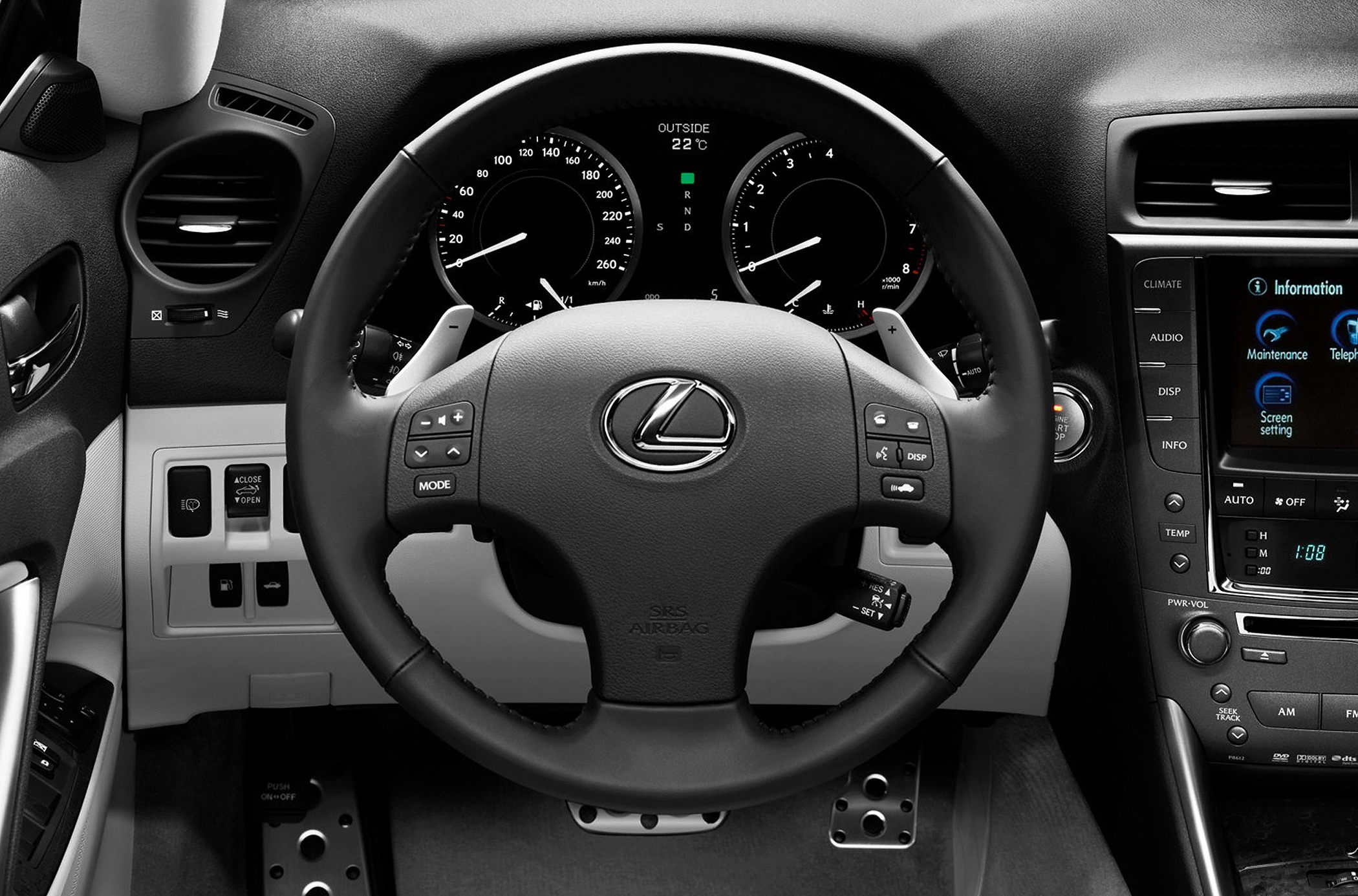 Steering wheel, instrument panel, control buttons, and pedals in car interior