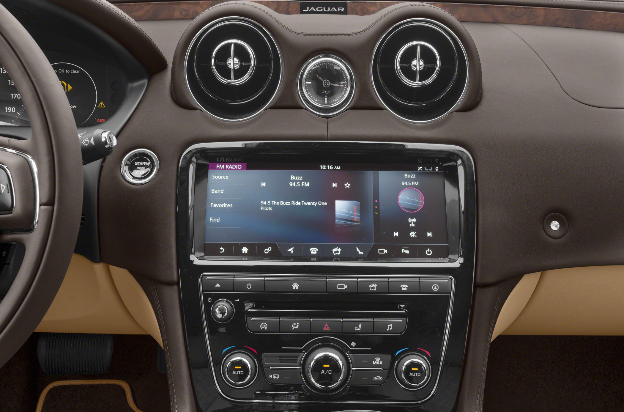 Luxury dashboard with dual round vents, analog clock, and touchscreen infotainment