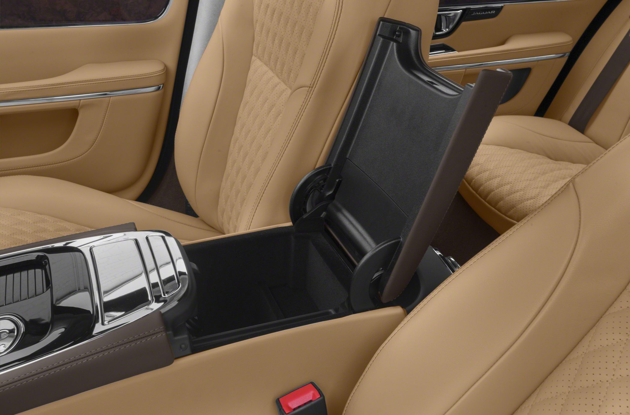 Tan leather seats and open center console storage in a luxury car interior.