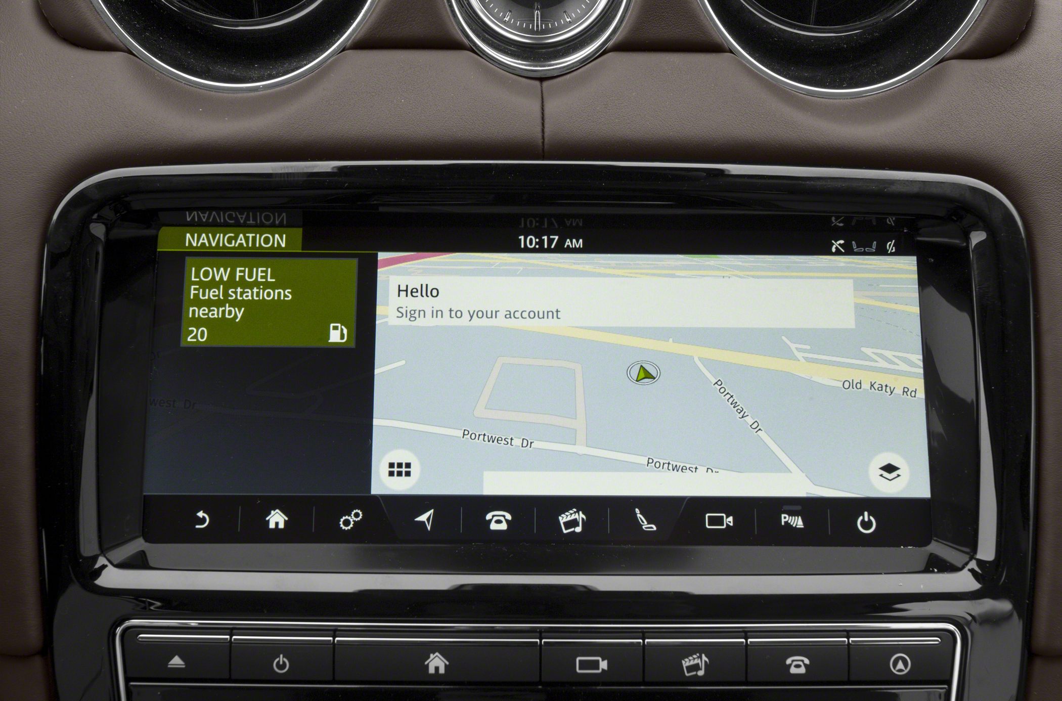 Car navigation system displaying low fuel alert and nearby fuel stations