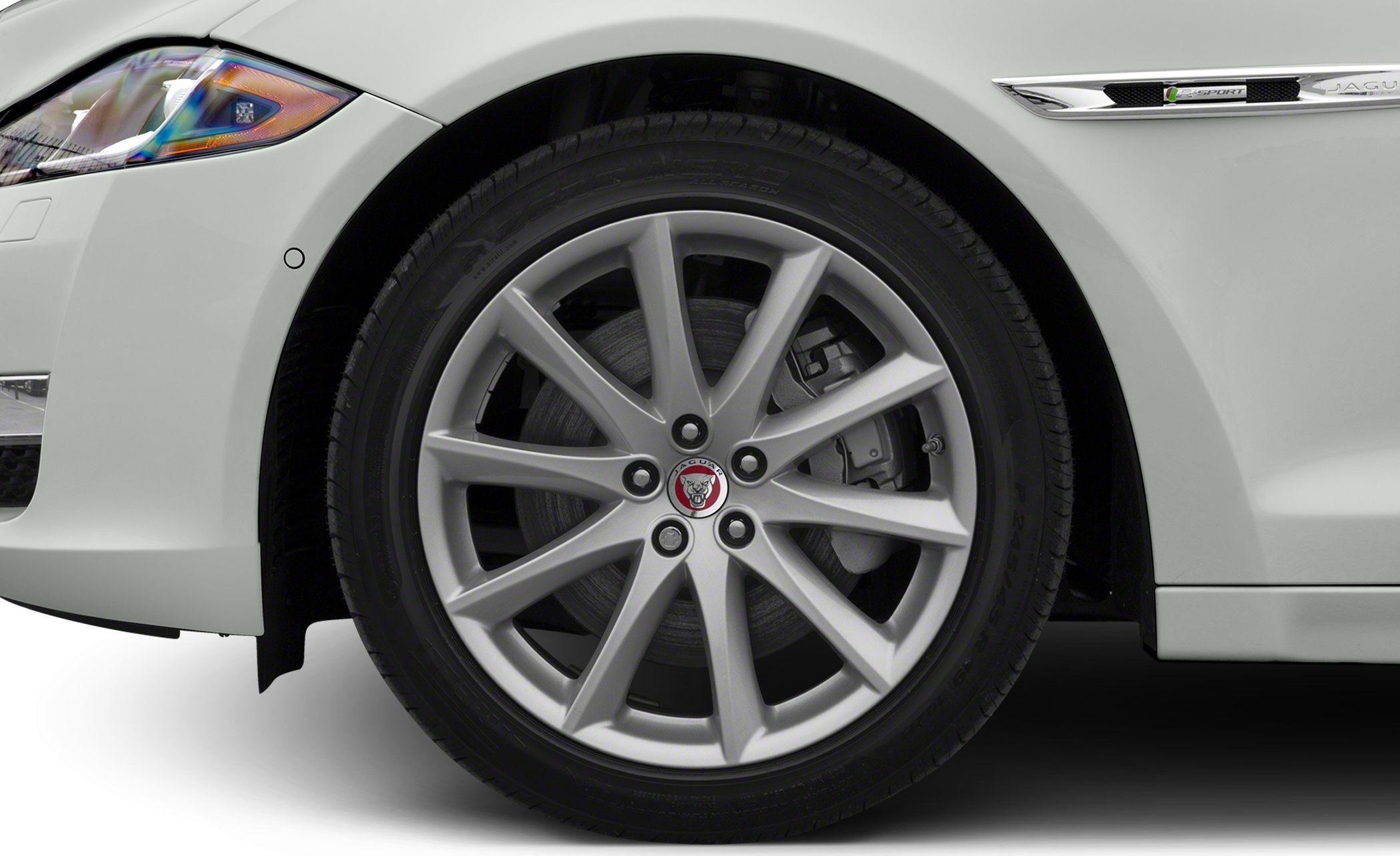 Alloy wheel with brake disc and front fender emblem detail.