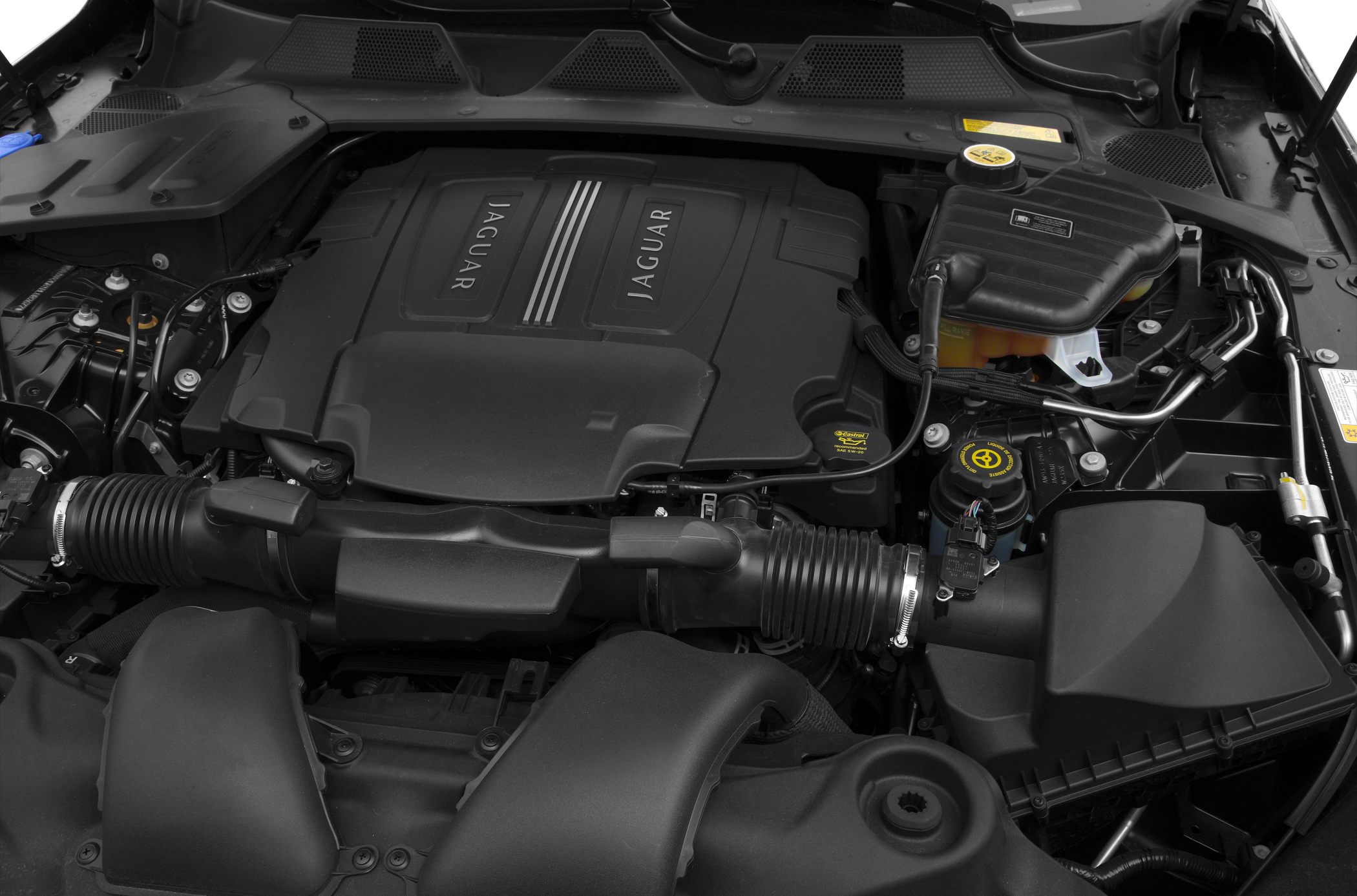 Close-up of engine bay with Jaguar-branded engine cover and surrounding components