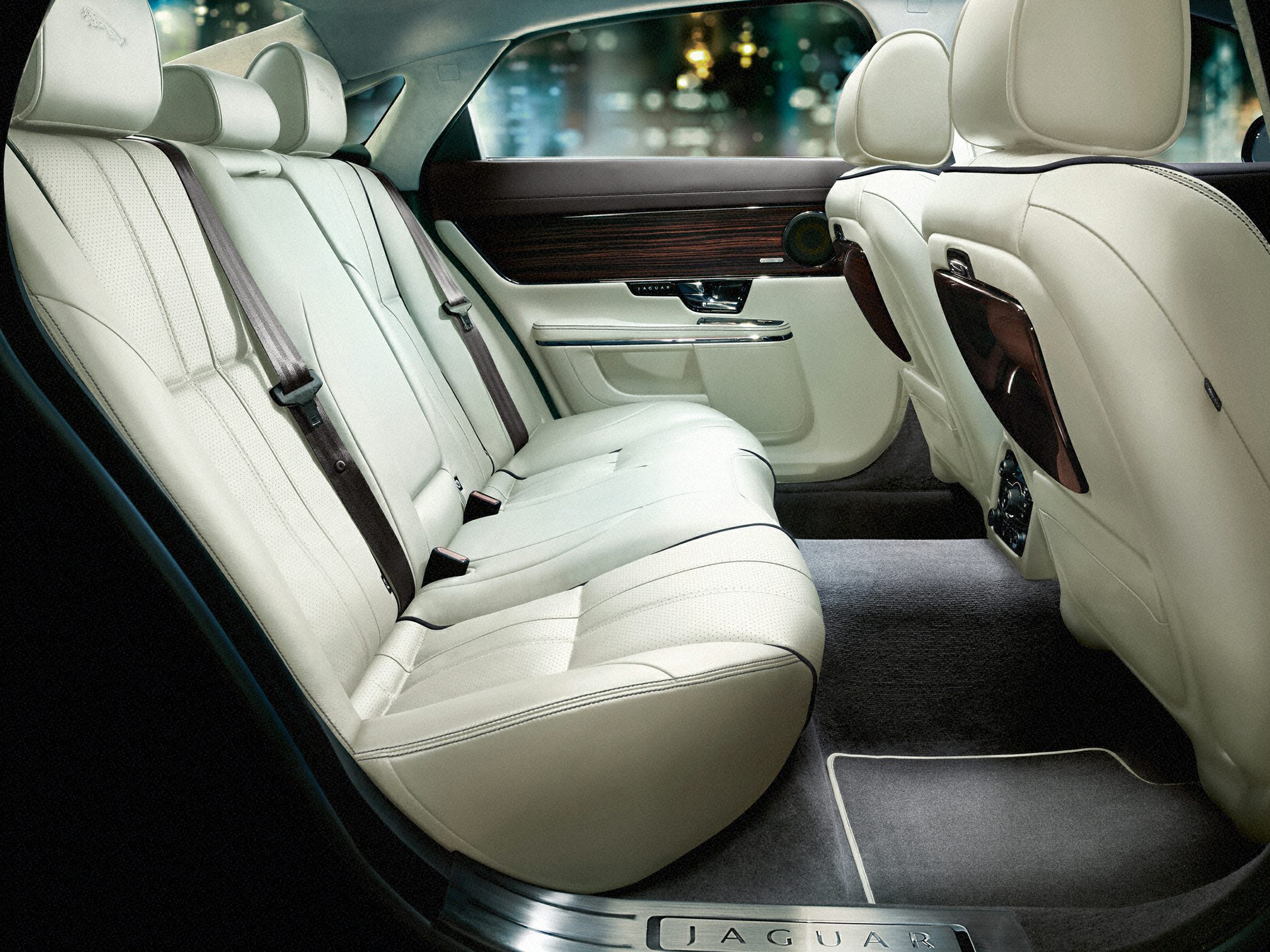Luxurious rear passenger seating with cream leather and wood trim