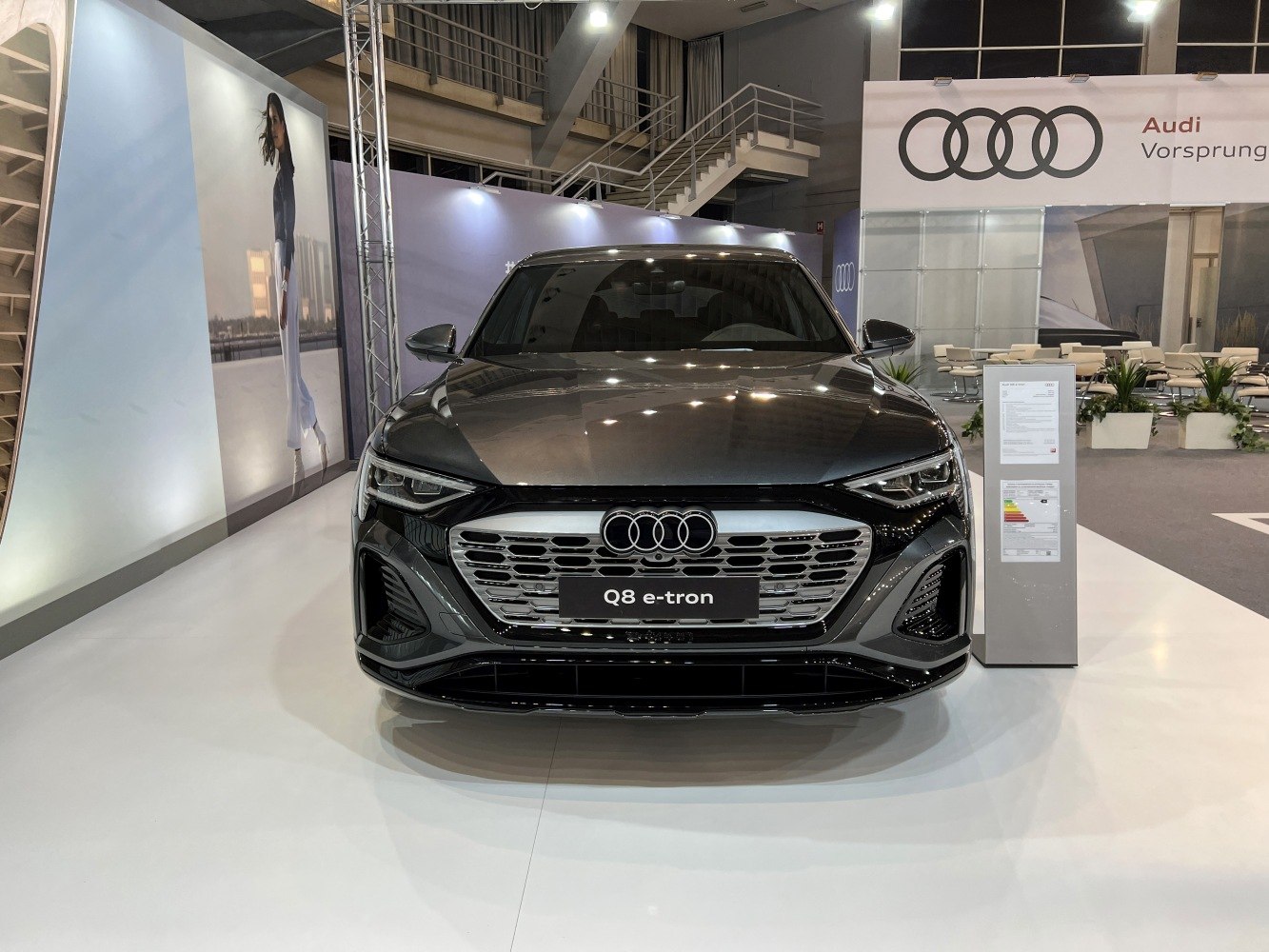 Front view of a sleek electric SUV with LED headlights and futuristic grille