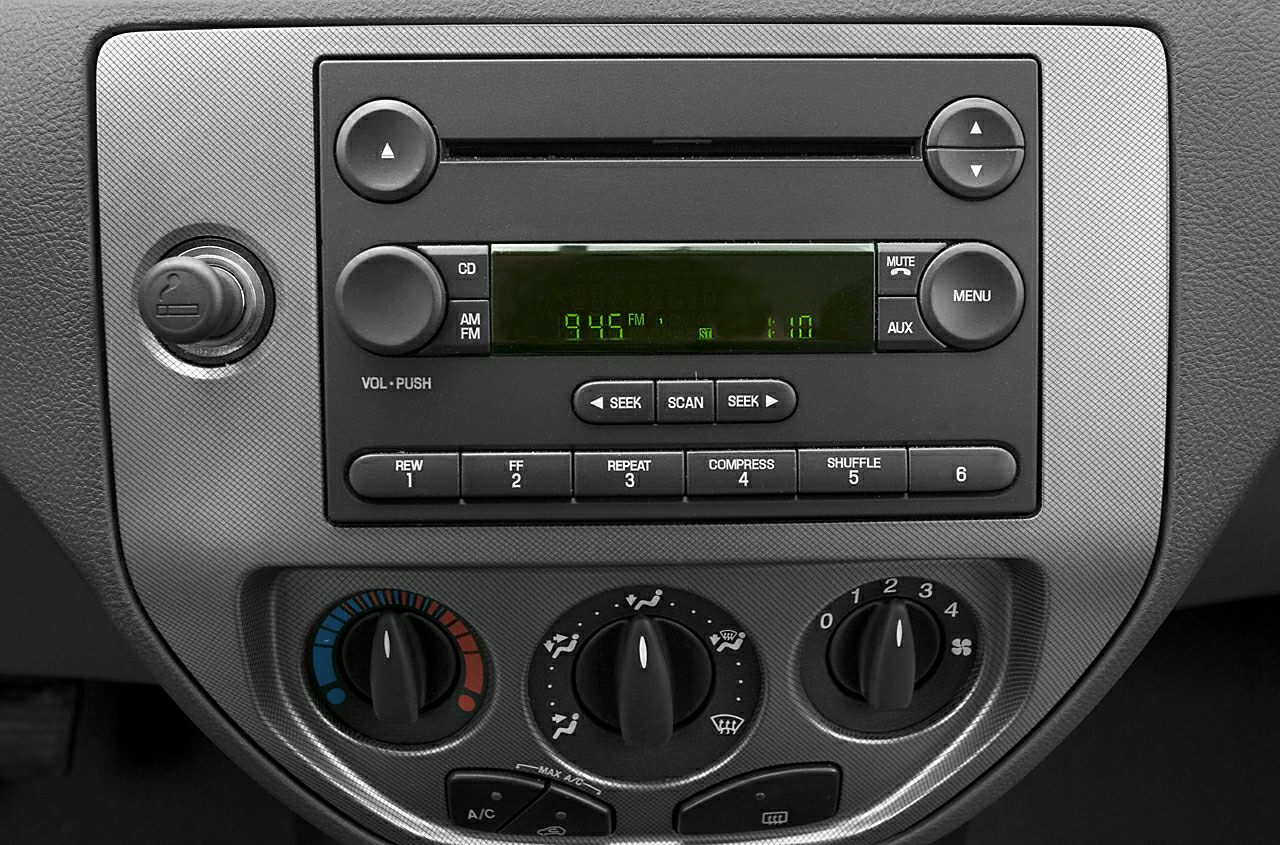 Car radio and climate control panel with dials and buttons