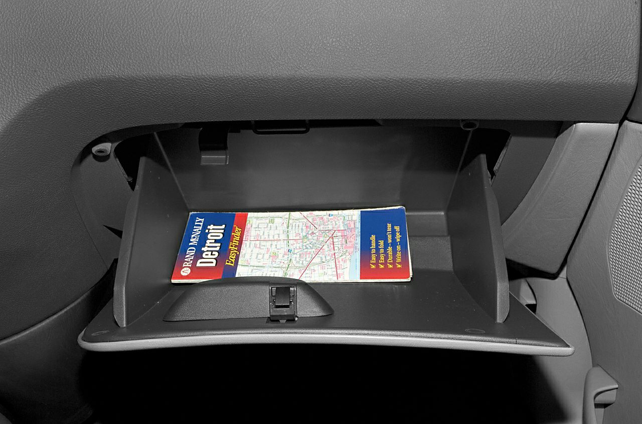 Open glove compartment with a map inside.
