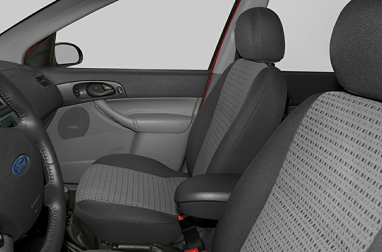 Front seats with patterned fabric upholstery and door panel with controls