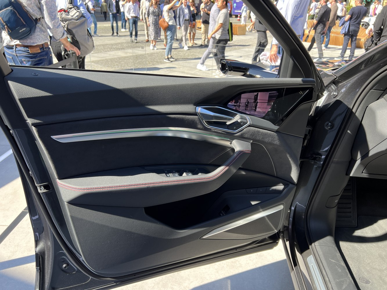 luxurious black interior door panel with modern controls and trim