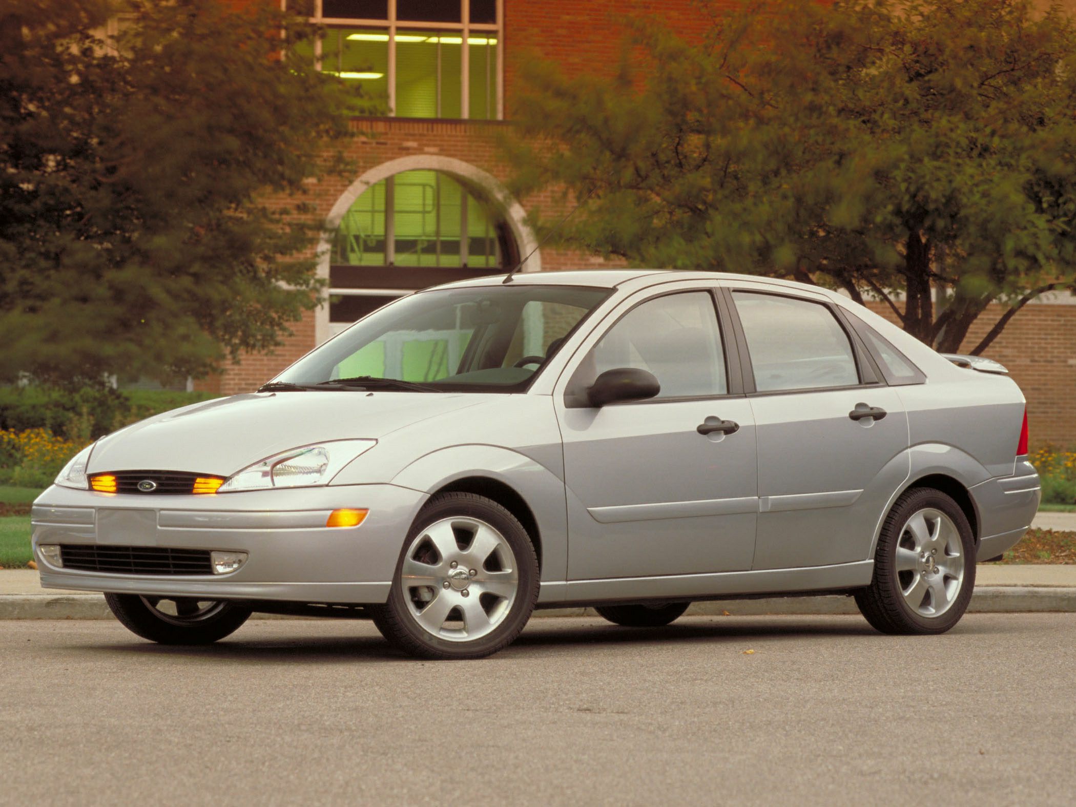 Four-door sedan with illuminated front turn signals and alloy wheels.