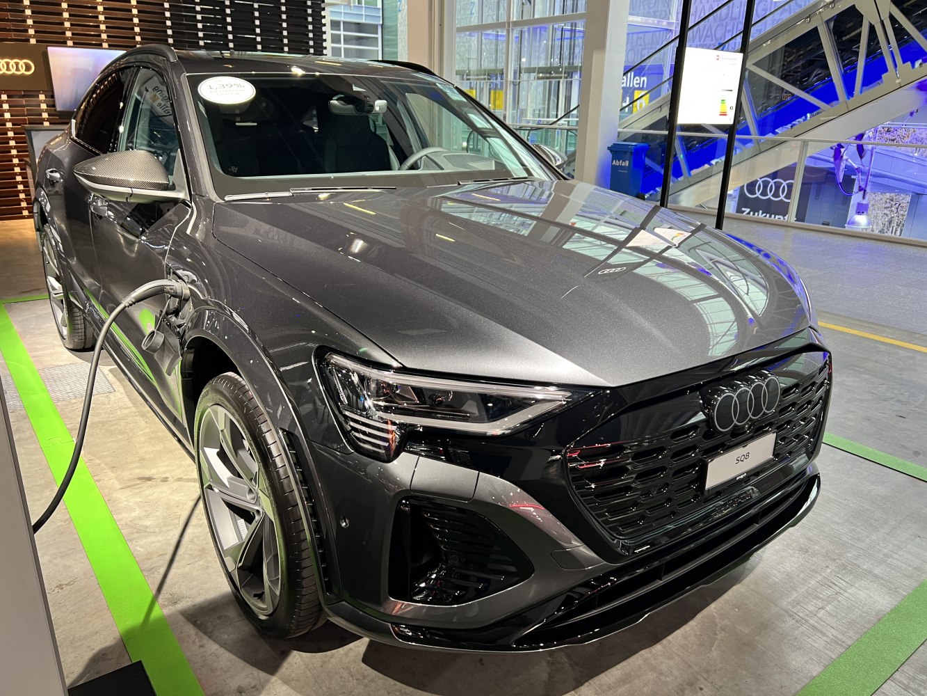 Sleek front and side charging port of an electric SUV with modern headlights