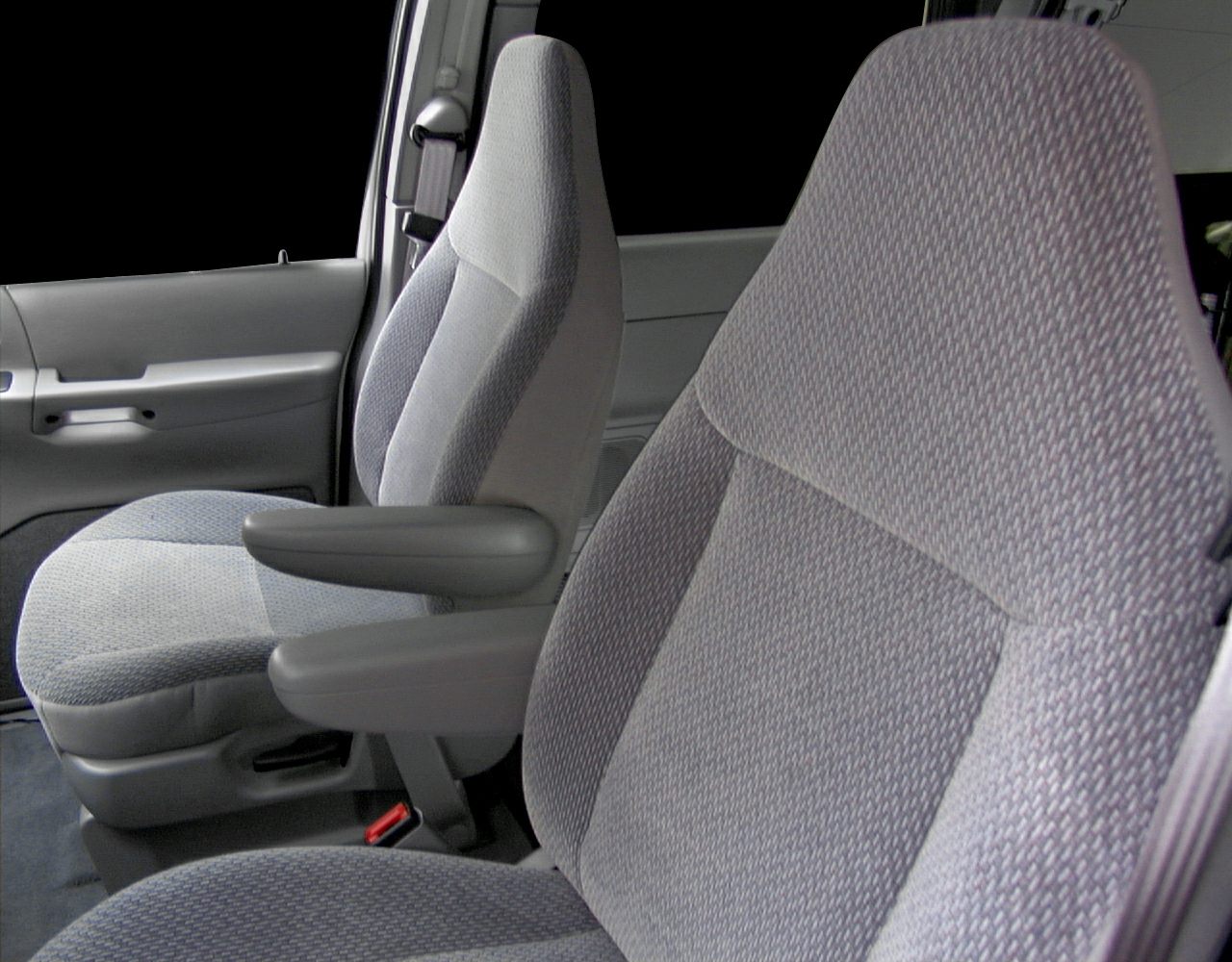 Plush fabric front seats and interior door panel with armrest.