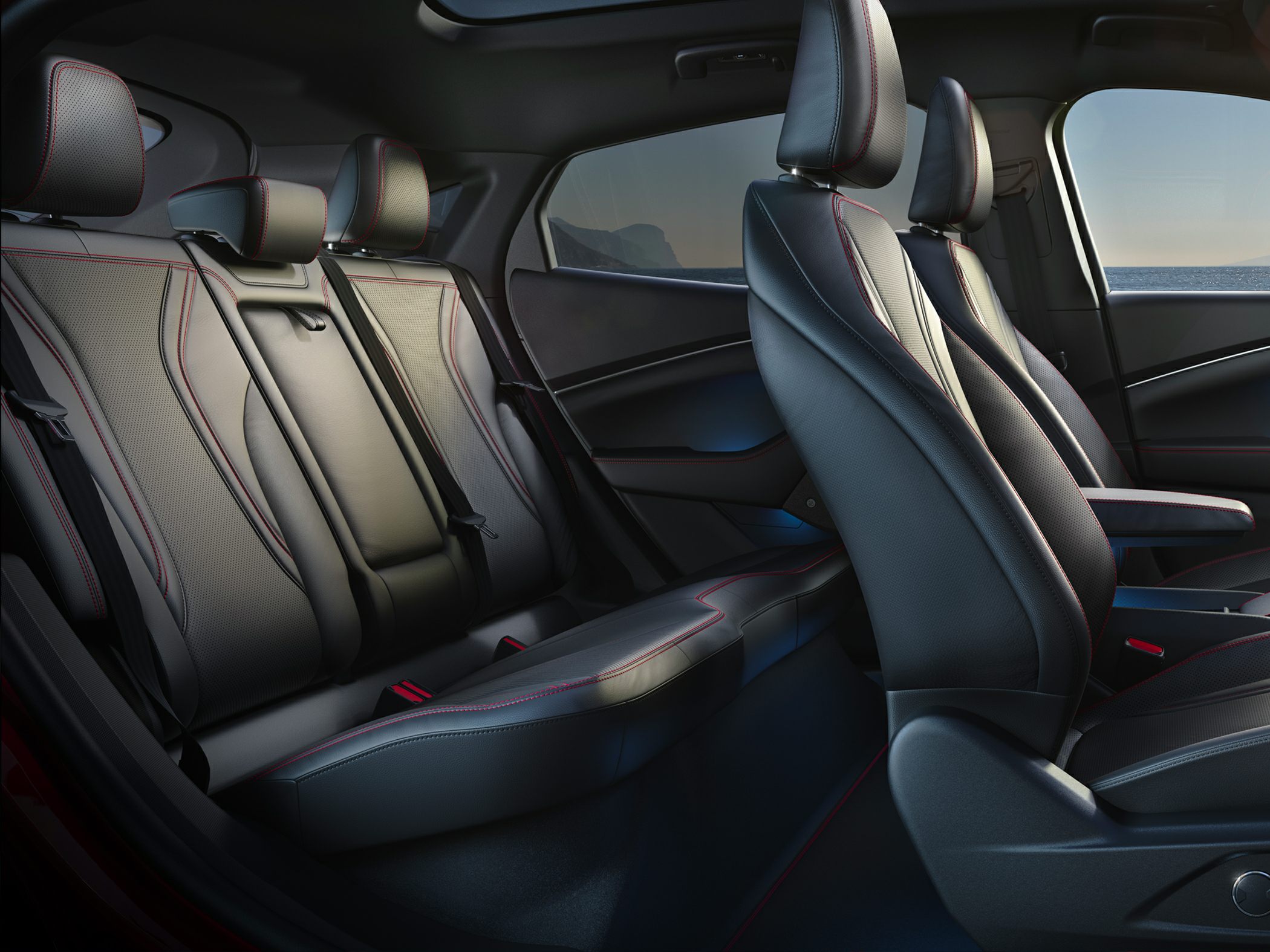 Black leather seating with red stitching and ergonomic design