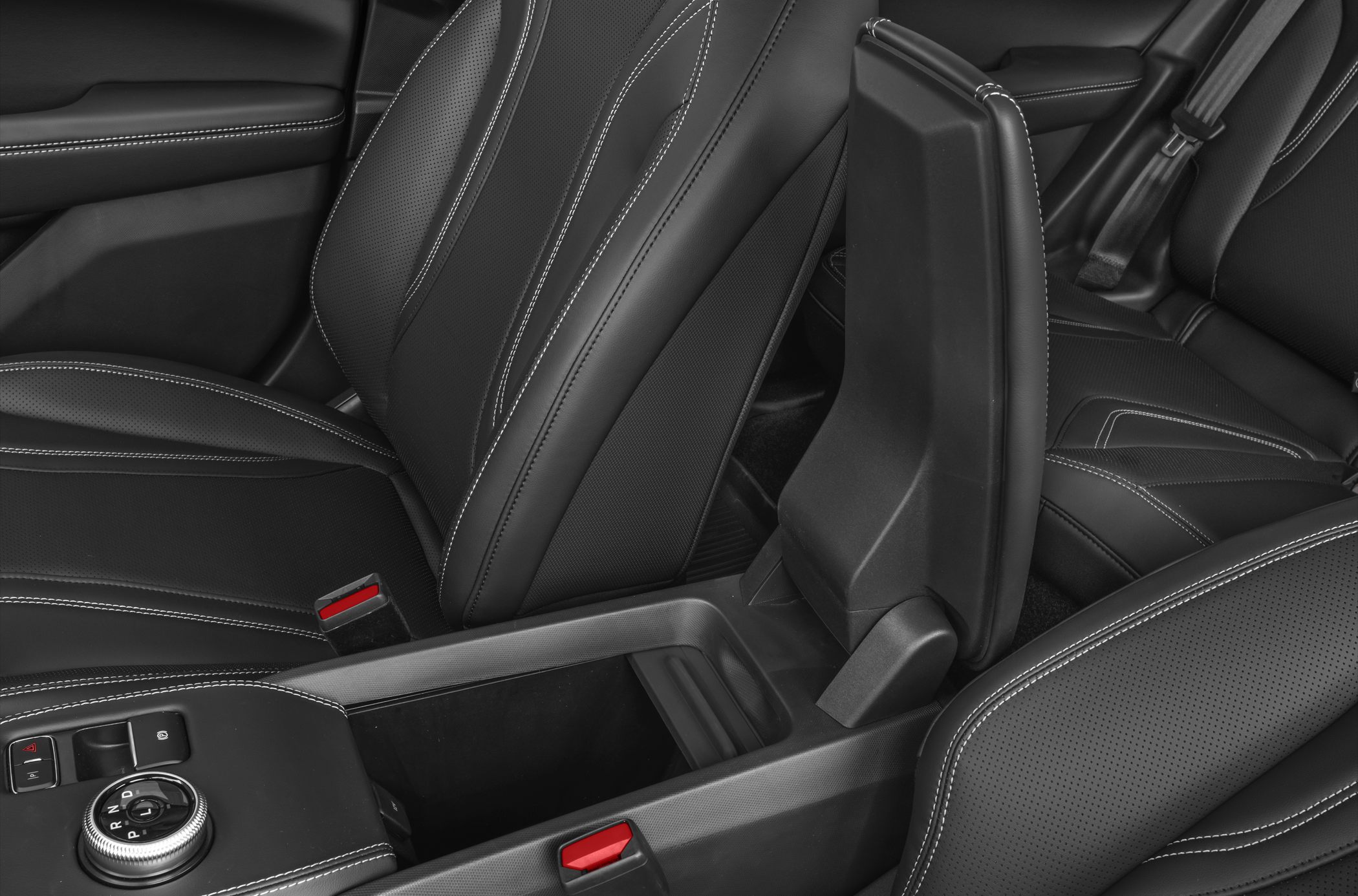 Center console and front seats with black upholstery and white stitching