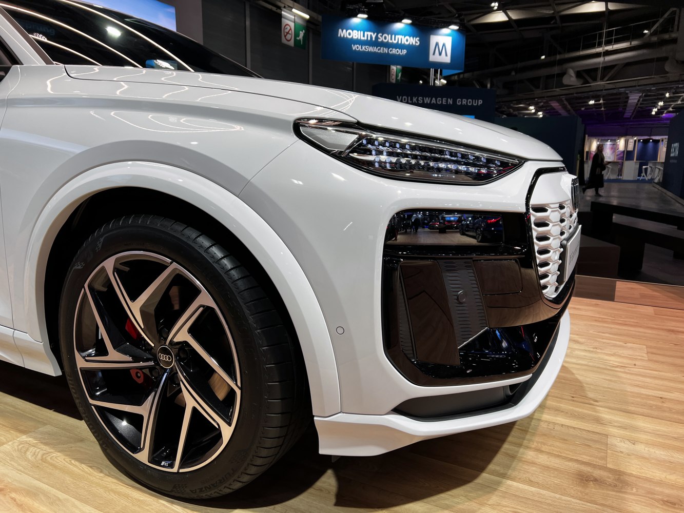 Close-up of front headlight and wheel with stylish alloy rim