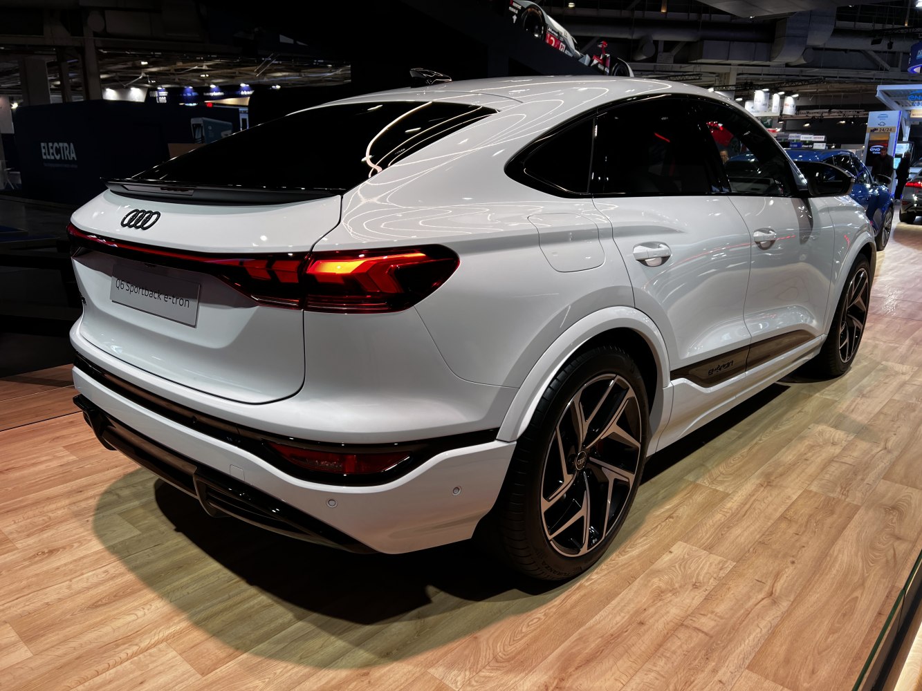 Rear and side view of an electric SUV with dynamic taillights and aerodynamic shape.