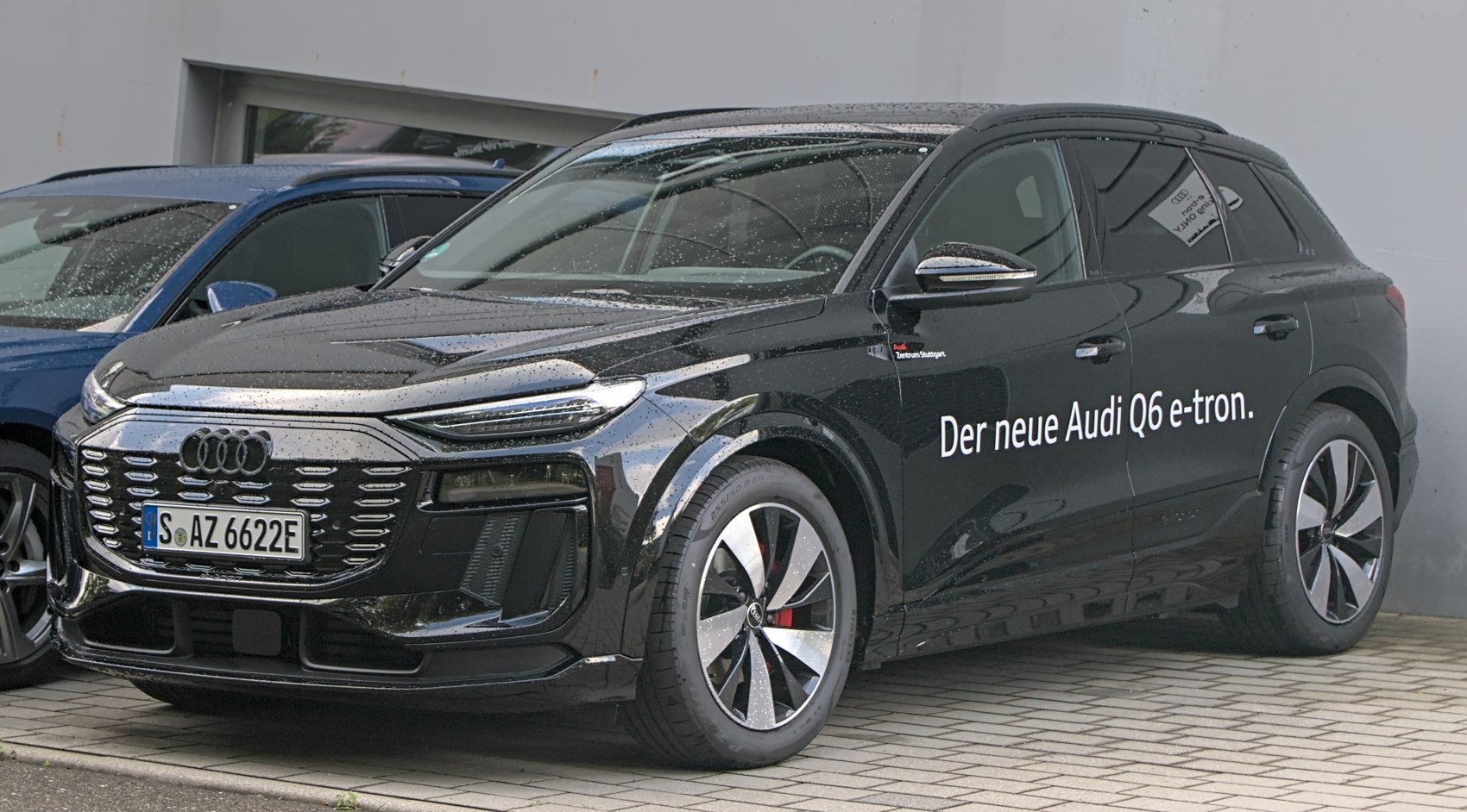 Front and side profile of a black electric SUV with LED headlights and alloy wheels.