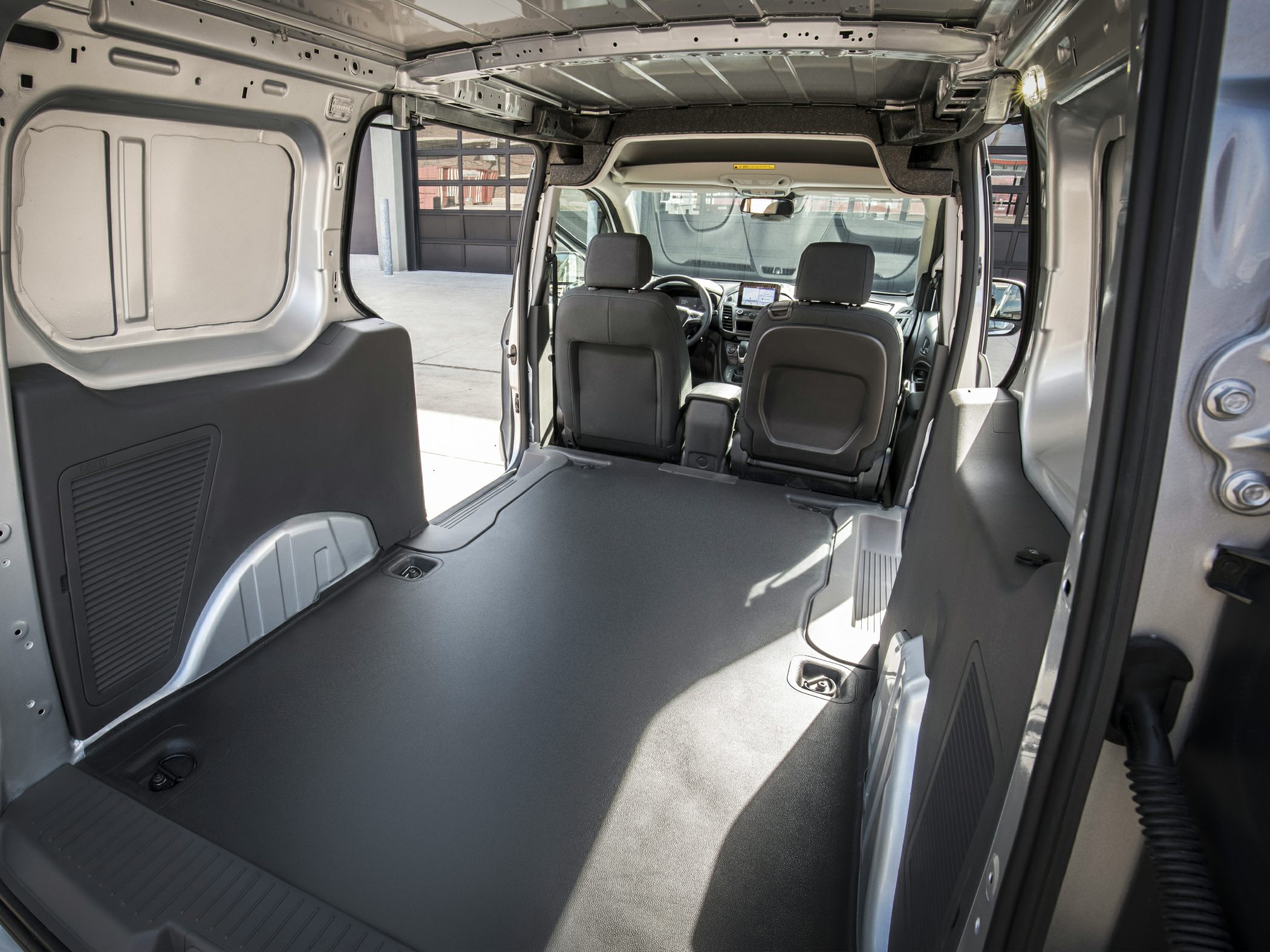 Spacious flat loading floor cargo area with visible front seats.
