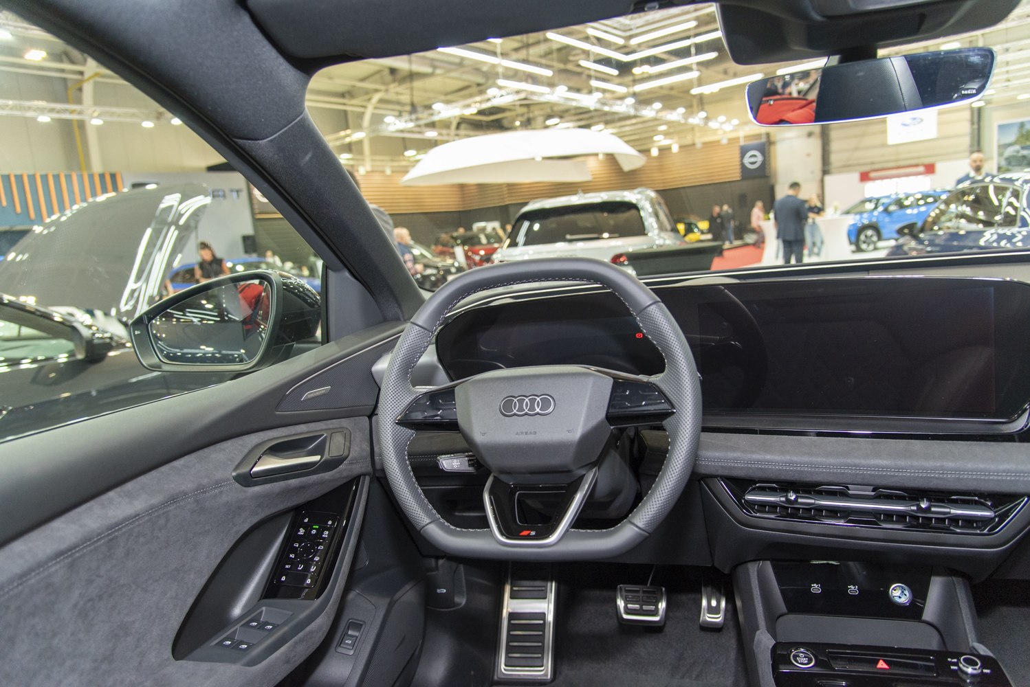 Digital cockpit and sporty steering wheel inside a vehicle