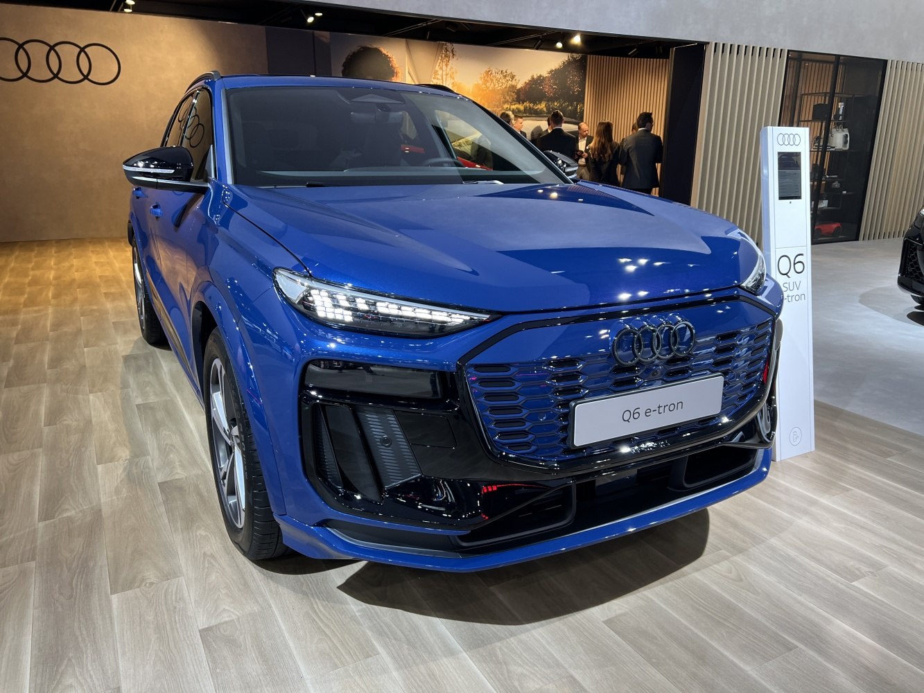 Front view of electric SUV with LED headlights and honeycomb grille.