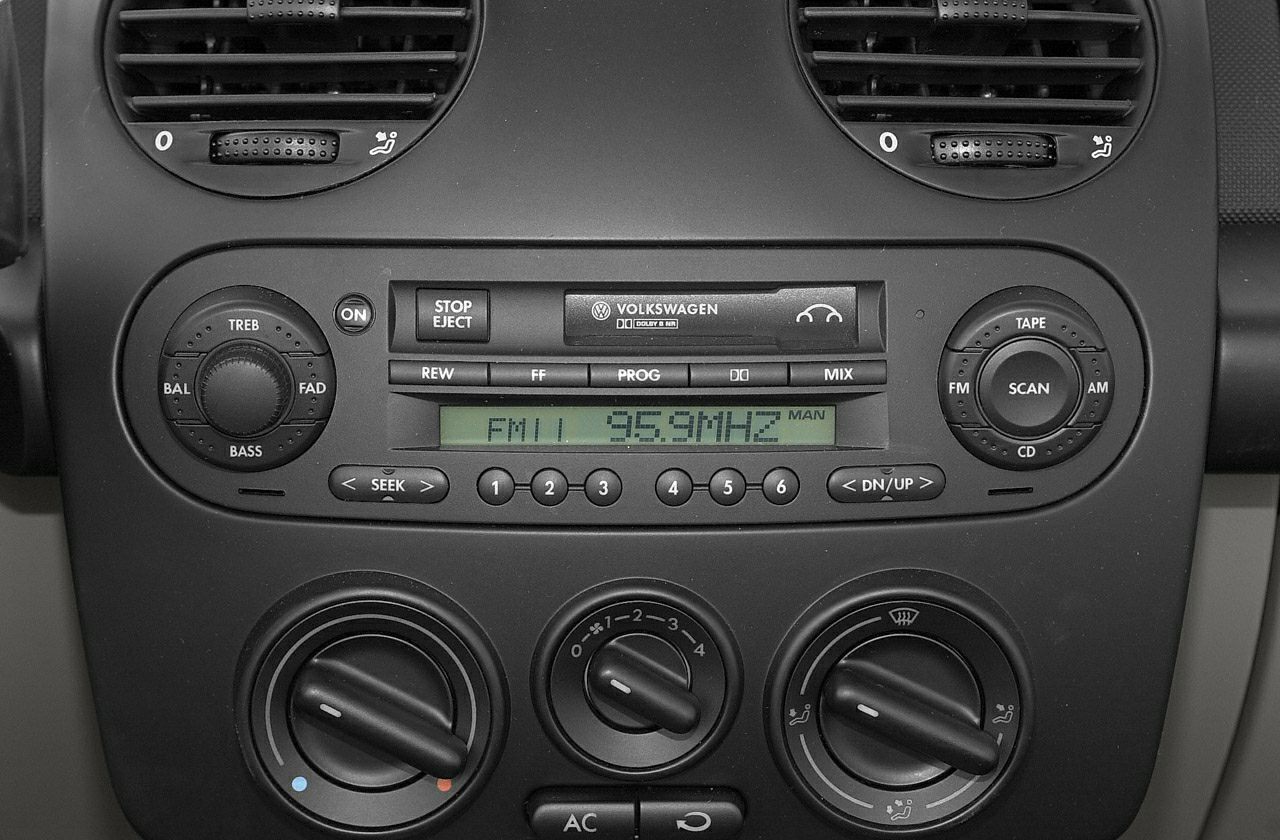 Manual tuning radio and climate control panel in car dashboard