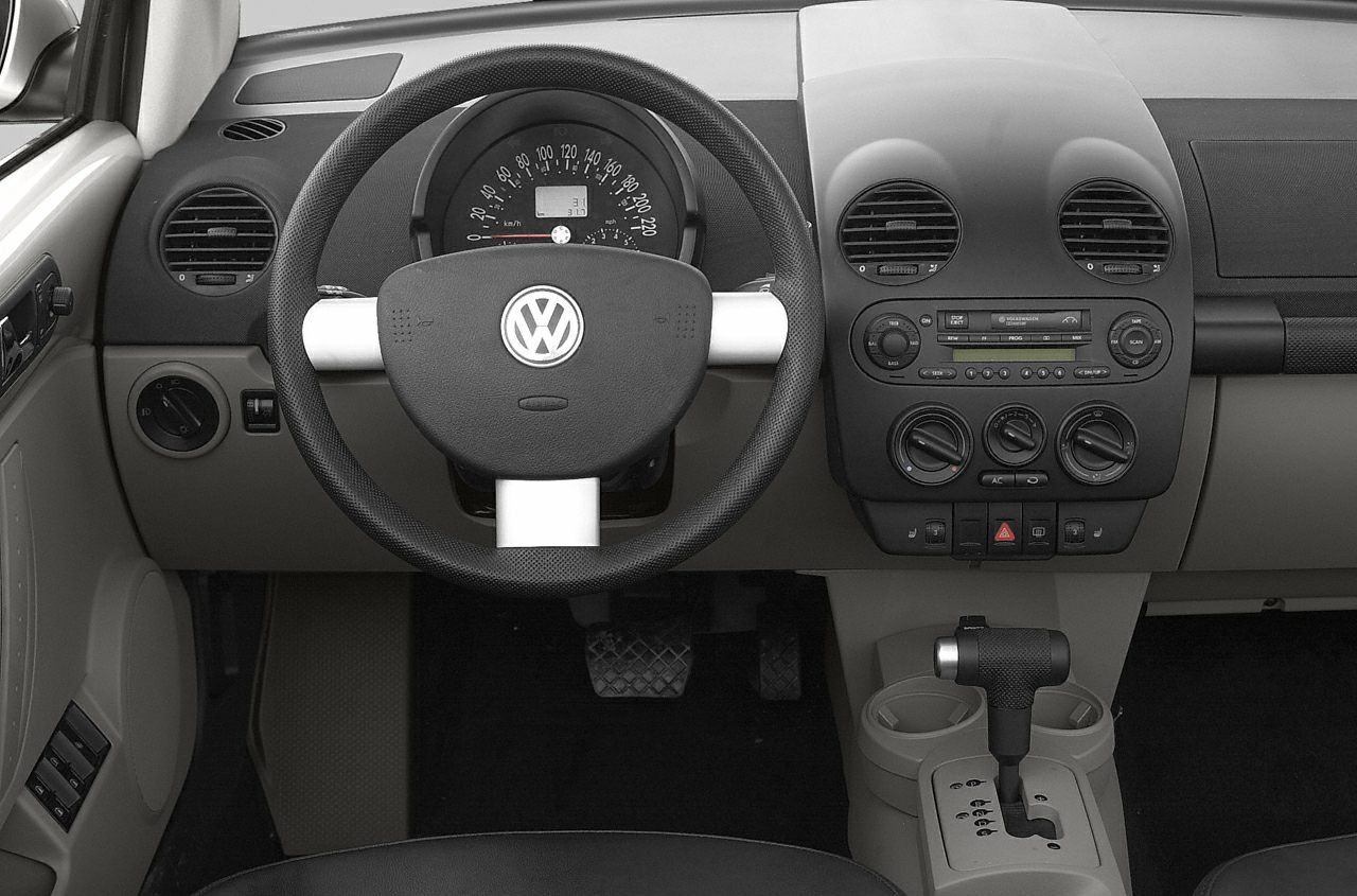 Dashboard and steering wheel with gear shift and climate controls.