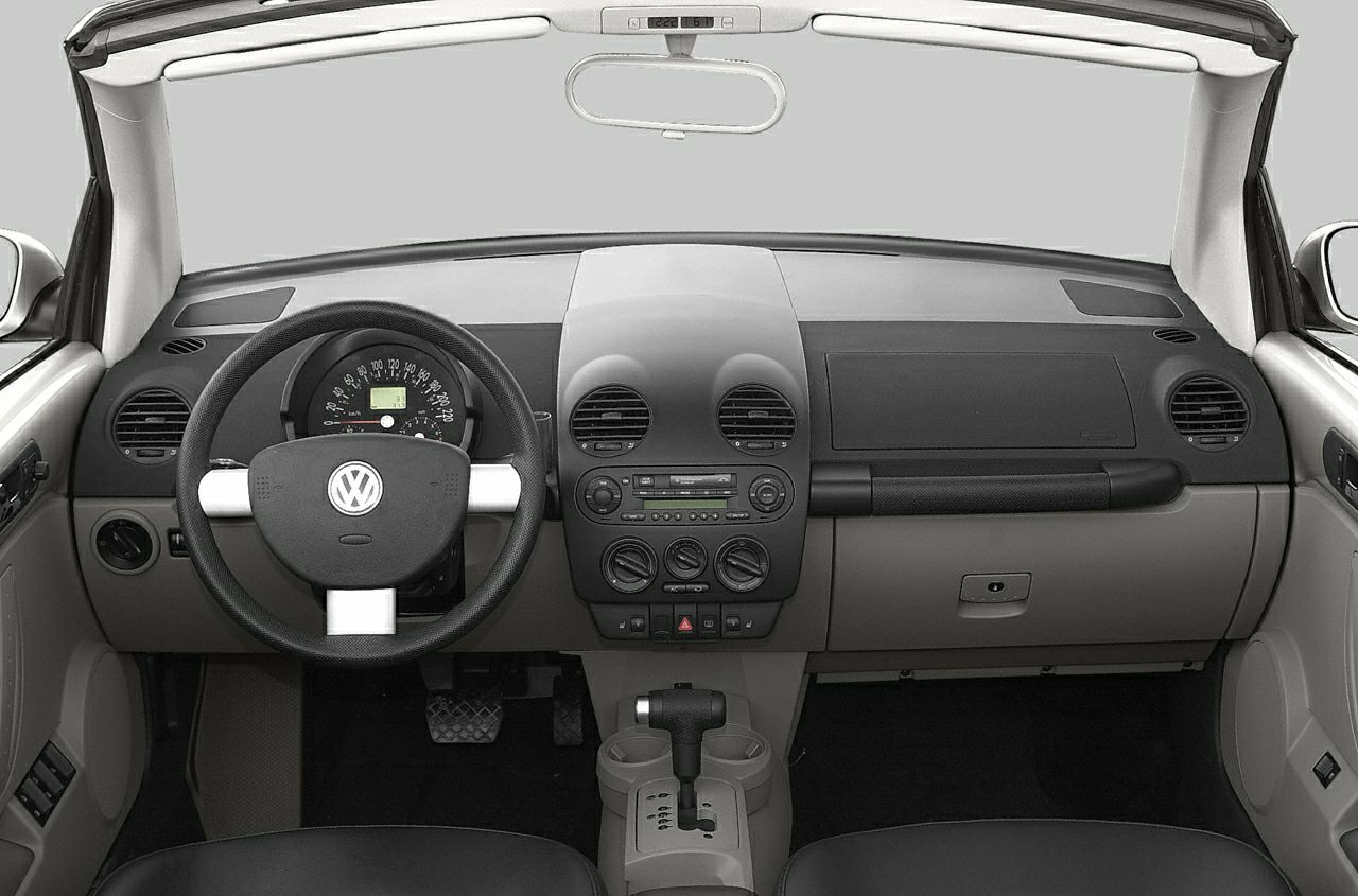 Dashboard and steering wheel with center console controls in a convertible interior