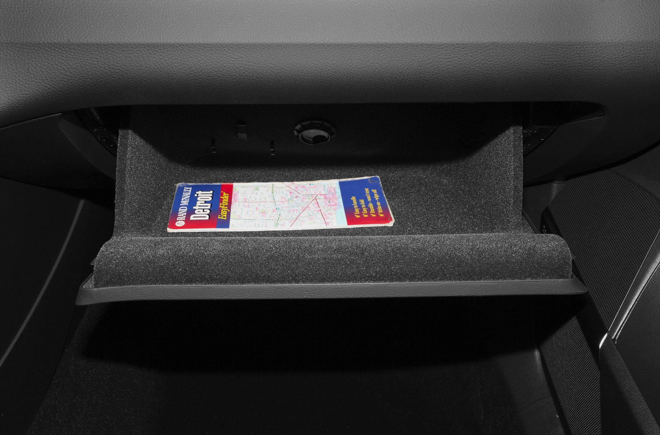 Glove compartment with map inside car interior