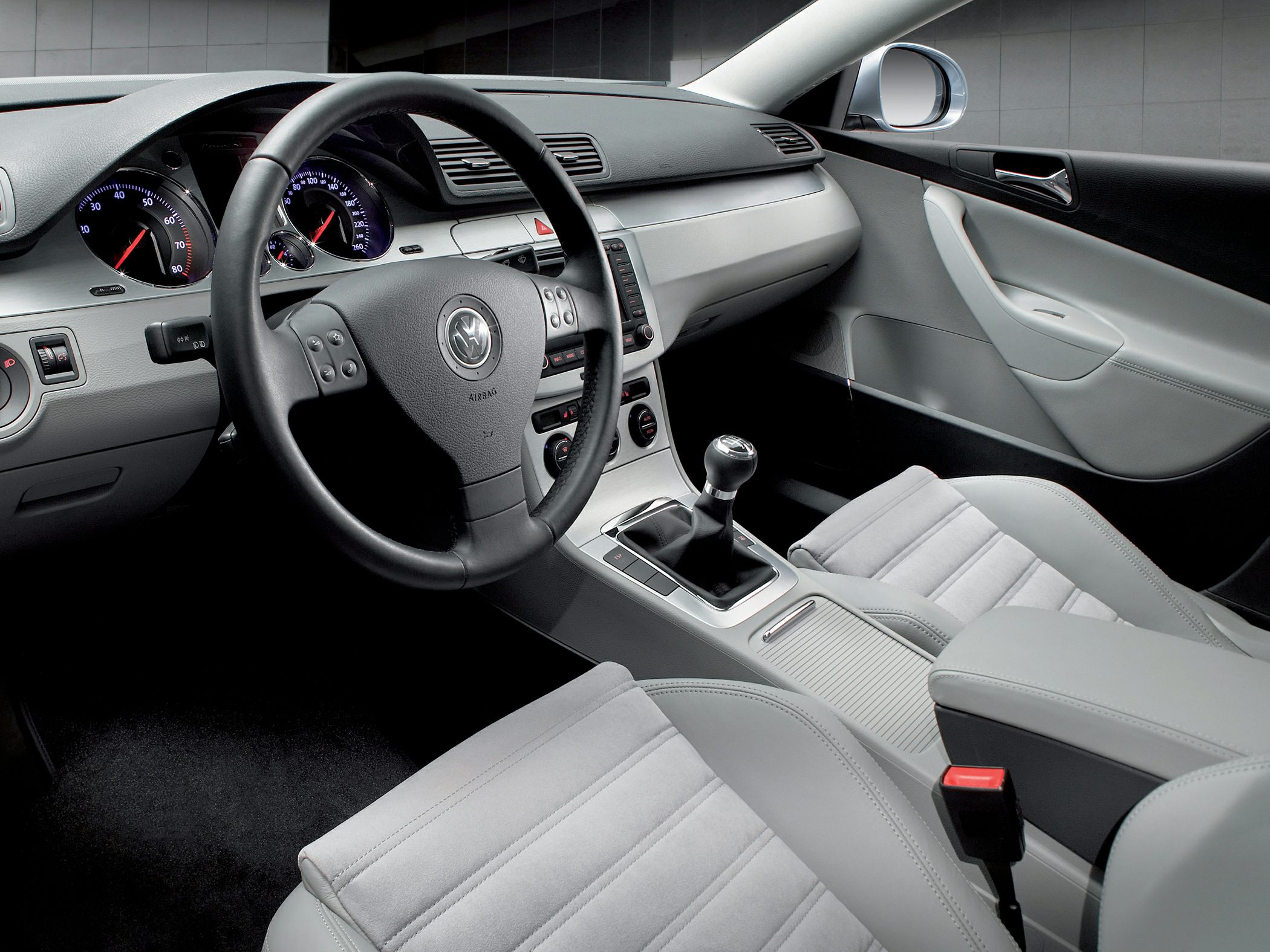 Leather steering wheel and manual gear shift in car interior