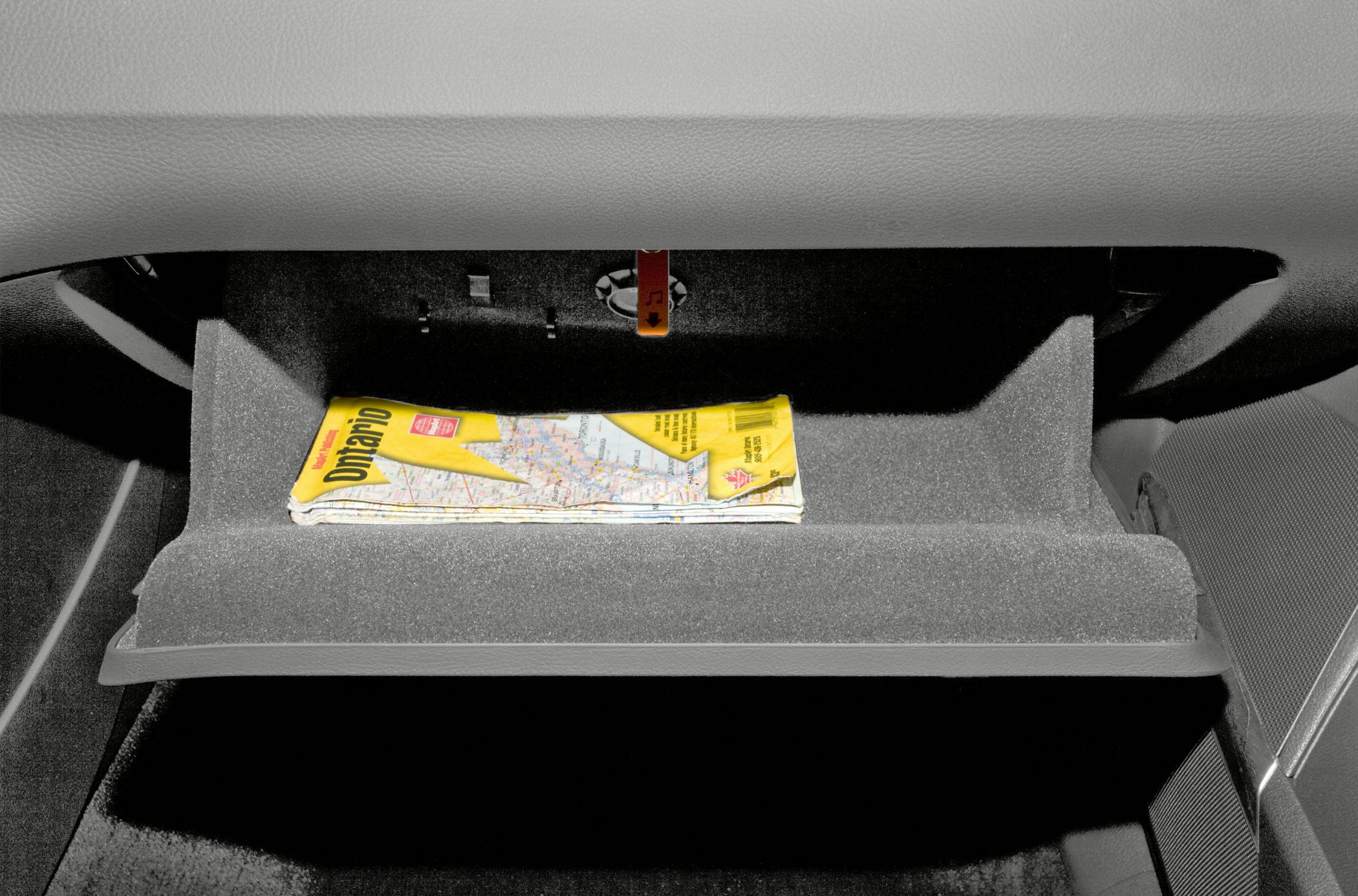 Open glove compartment with a folded map inside