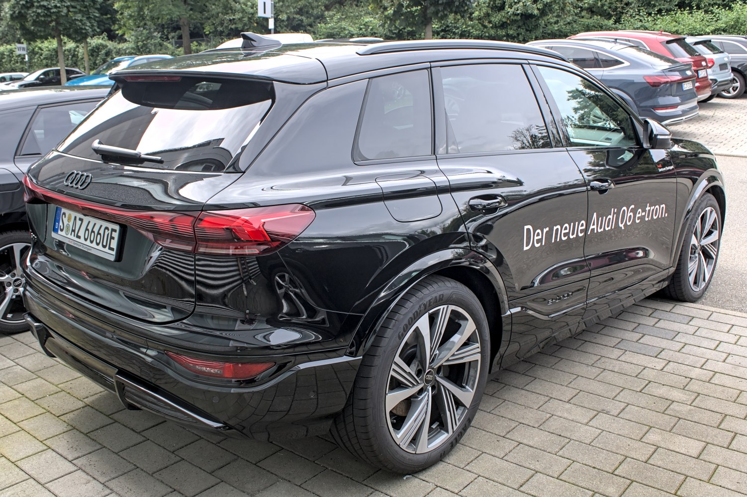 Rear and side view of a sleek black electric SUV with LED taillights and tinted windows