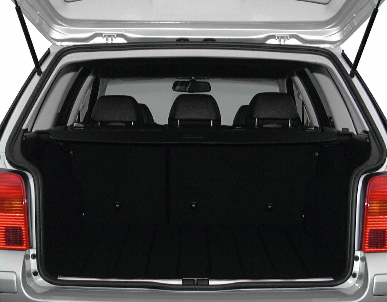 Open rear cargo area of a station wagon with rear seats.