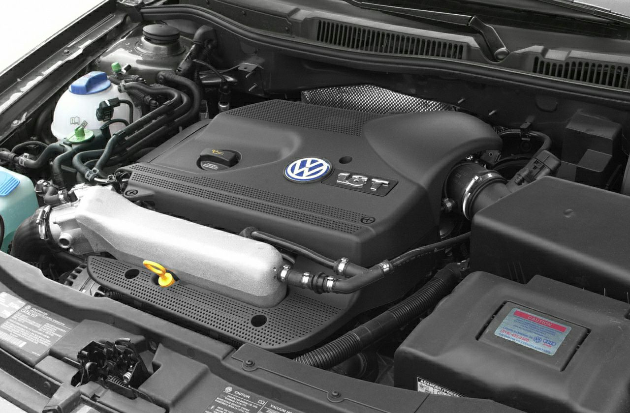 Turbocharged 1.8T engine bay with prominent Volkswagen engine cover
