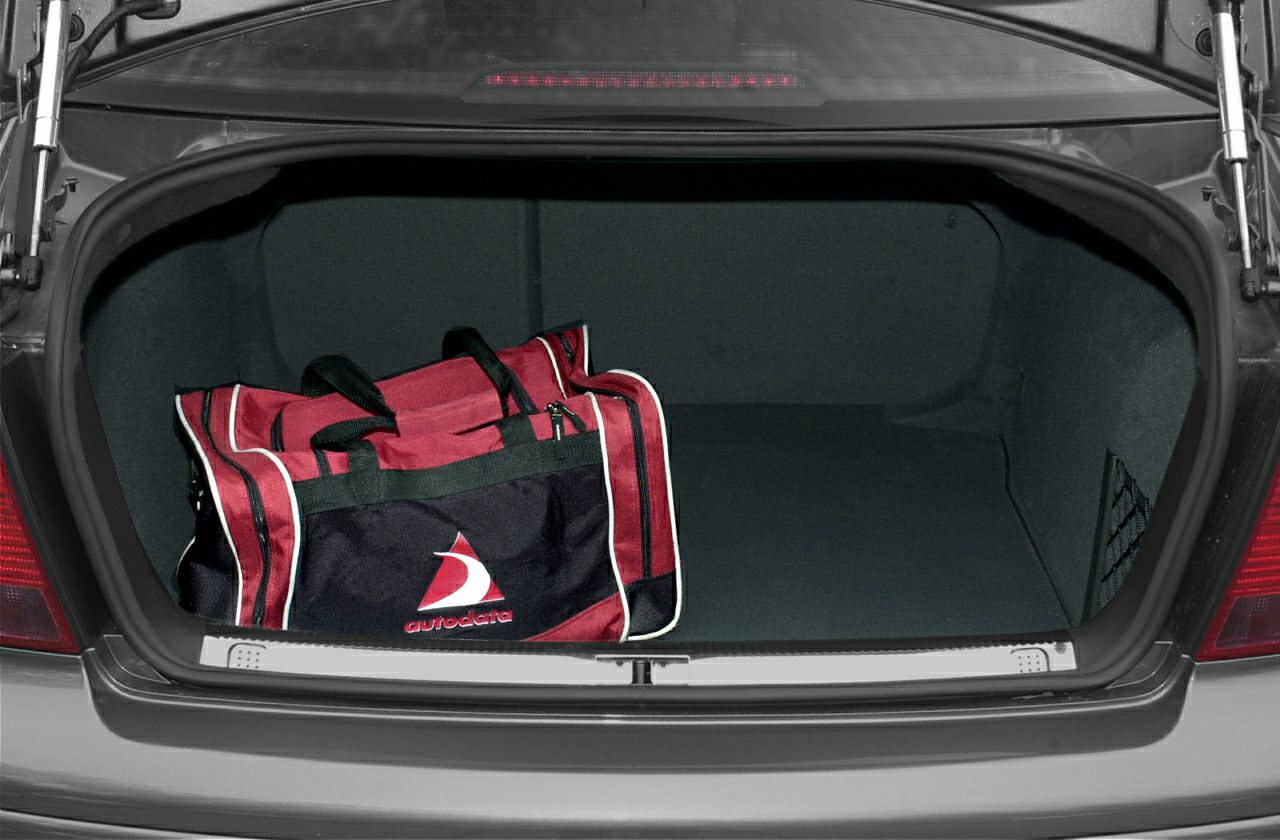 Large open car trunk with red travel bag inside
