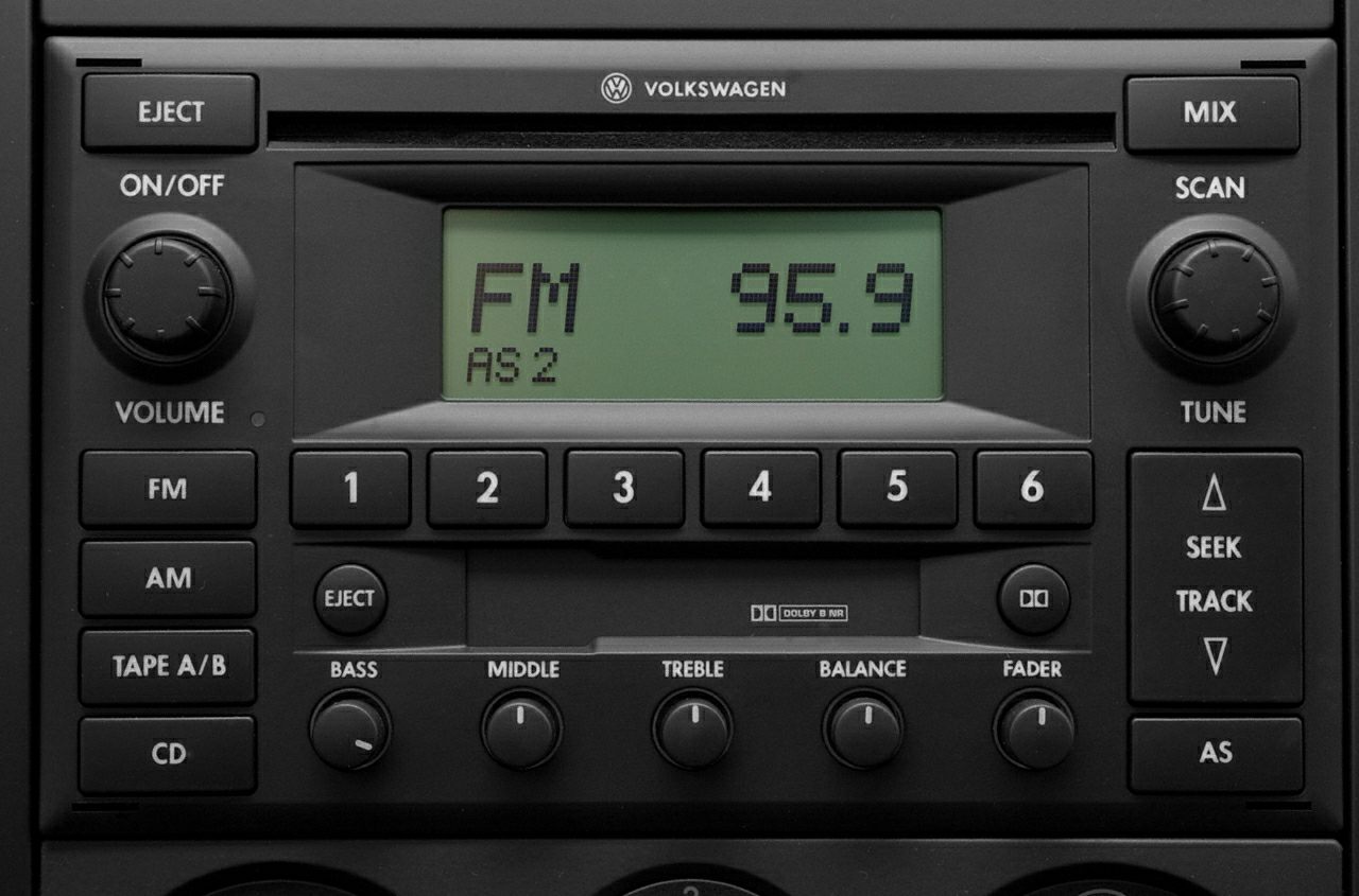 Vintage car radio with FM/AM, CD, tape, and sound adjustment knobs