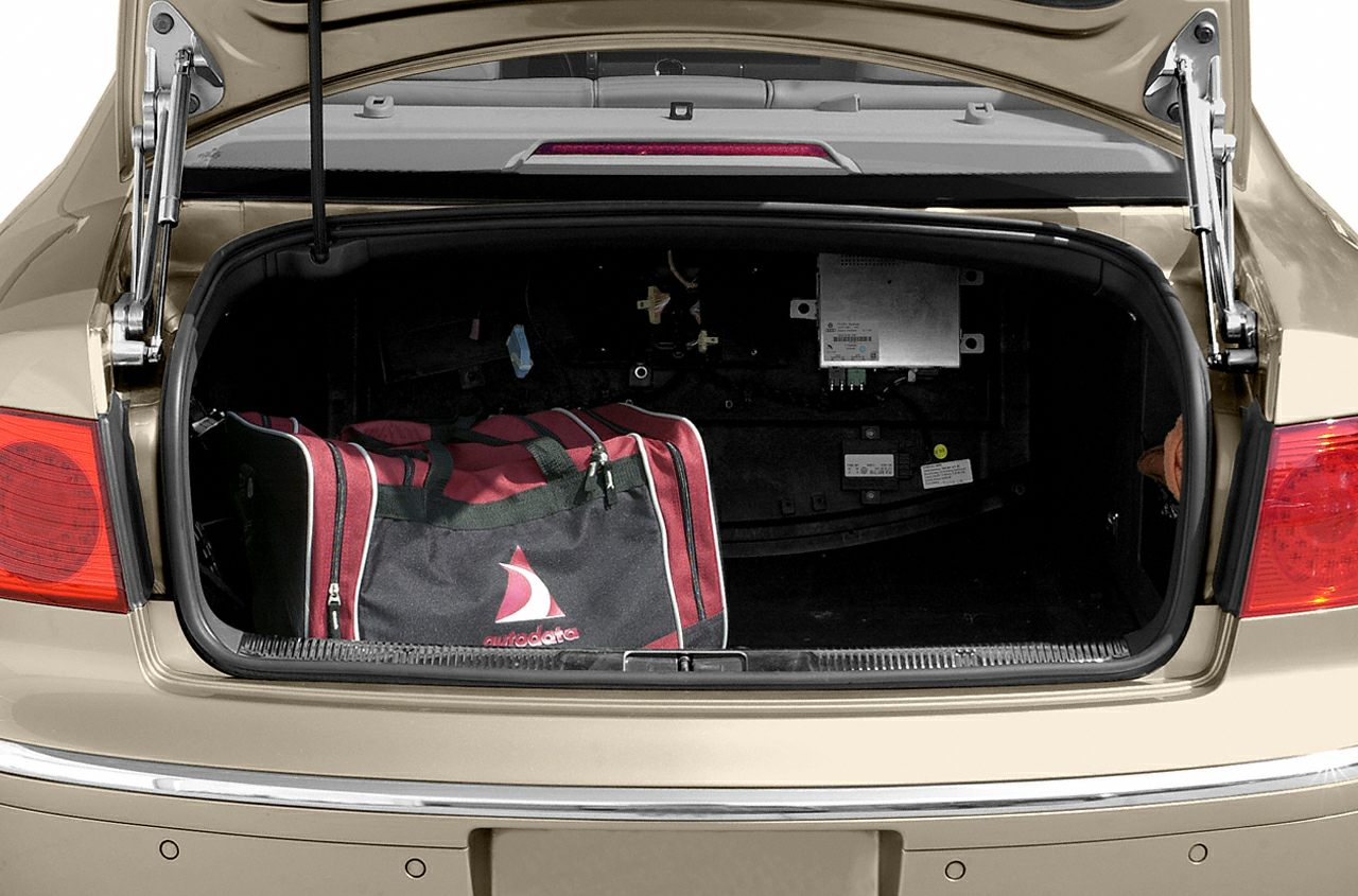 Open car trunk with red and black duffle bag inside