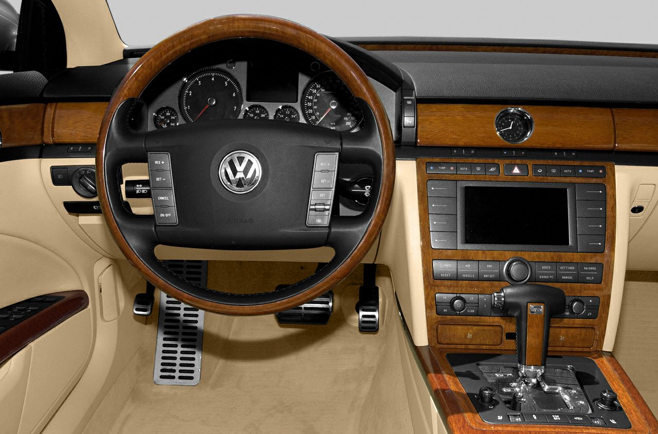 Luxury interior with wood trim, dashboard, and multifunction steering wheel