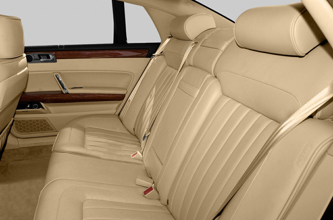 Beige leather rear seats with wood trim on door panels