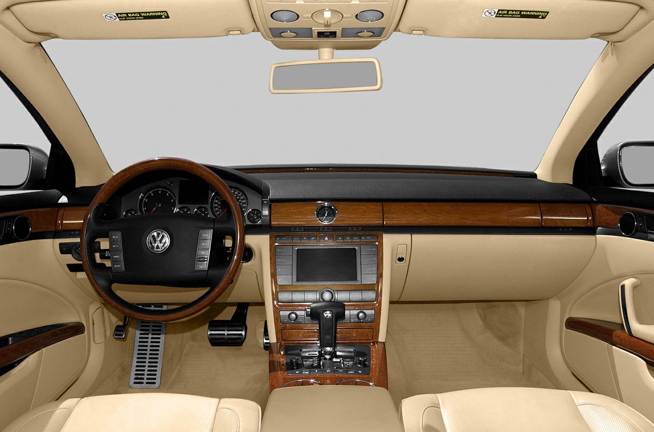 Beige leather interior with elegant wood trim dashboard and steering wheel