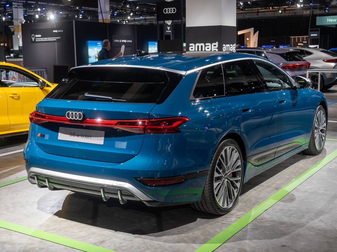 Rear side view of blue electric performance wagon with LED taillights.
