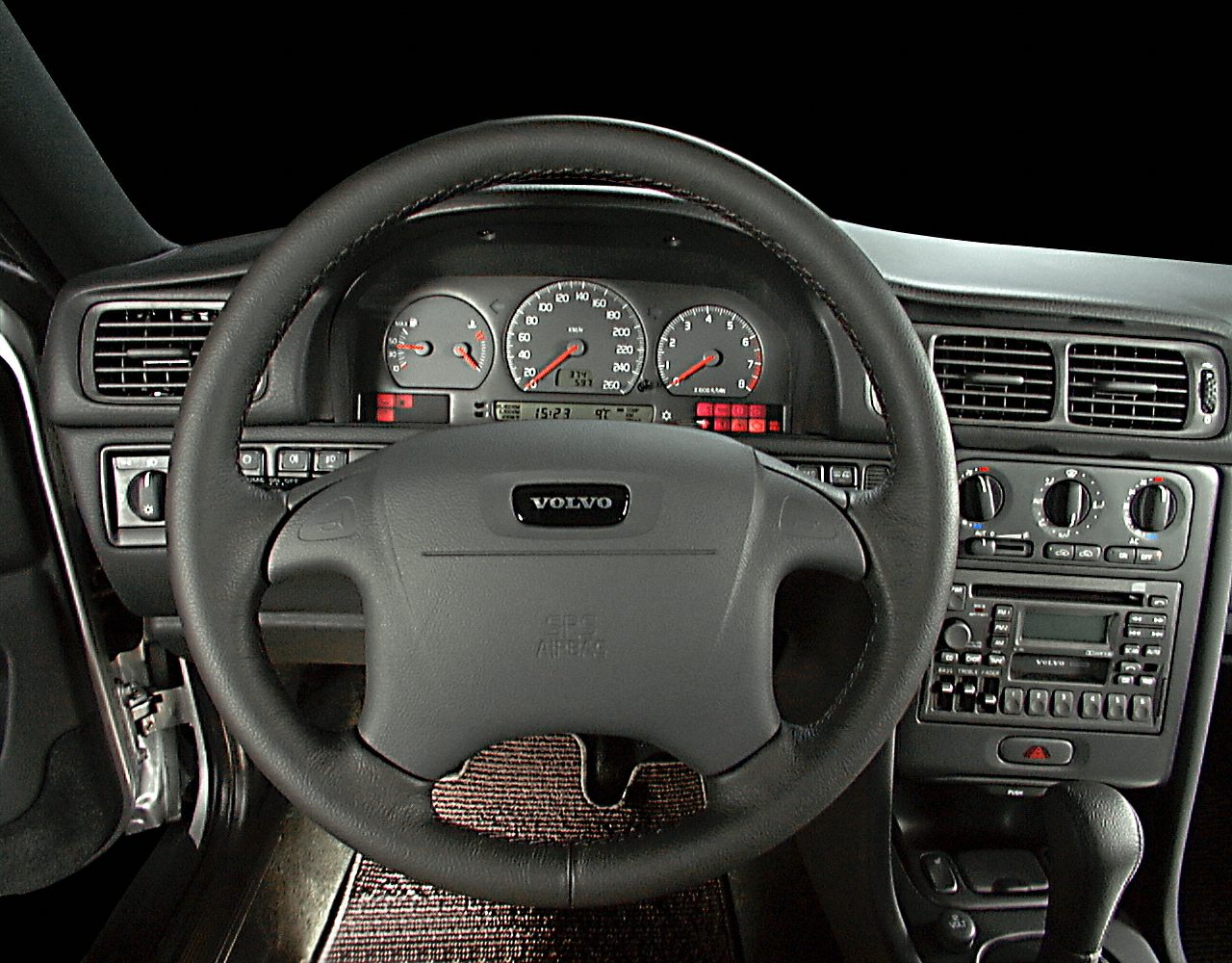 Steering wheel and dashboard with gauges and climate controls