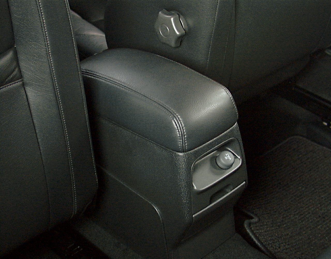 Black leather interior center console with power outlet and rear control knob