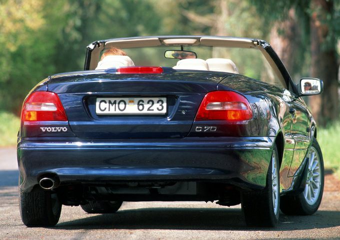 Rear view of dark blue convertible with taillights and single exhaust pipe