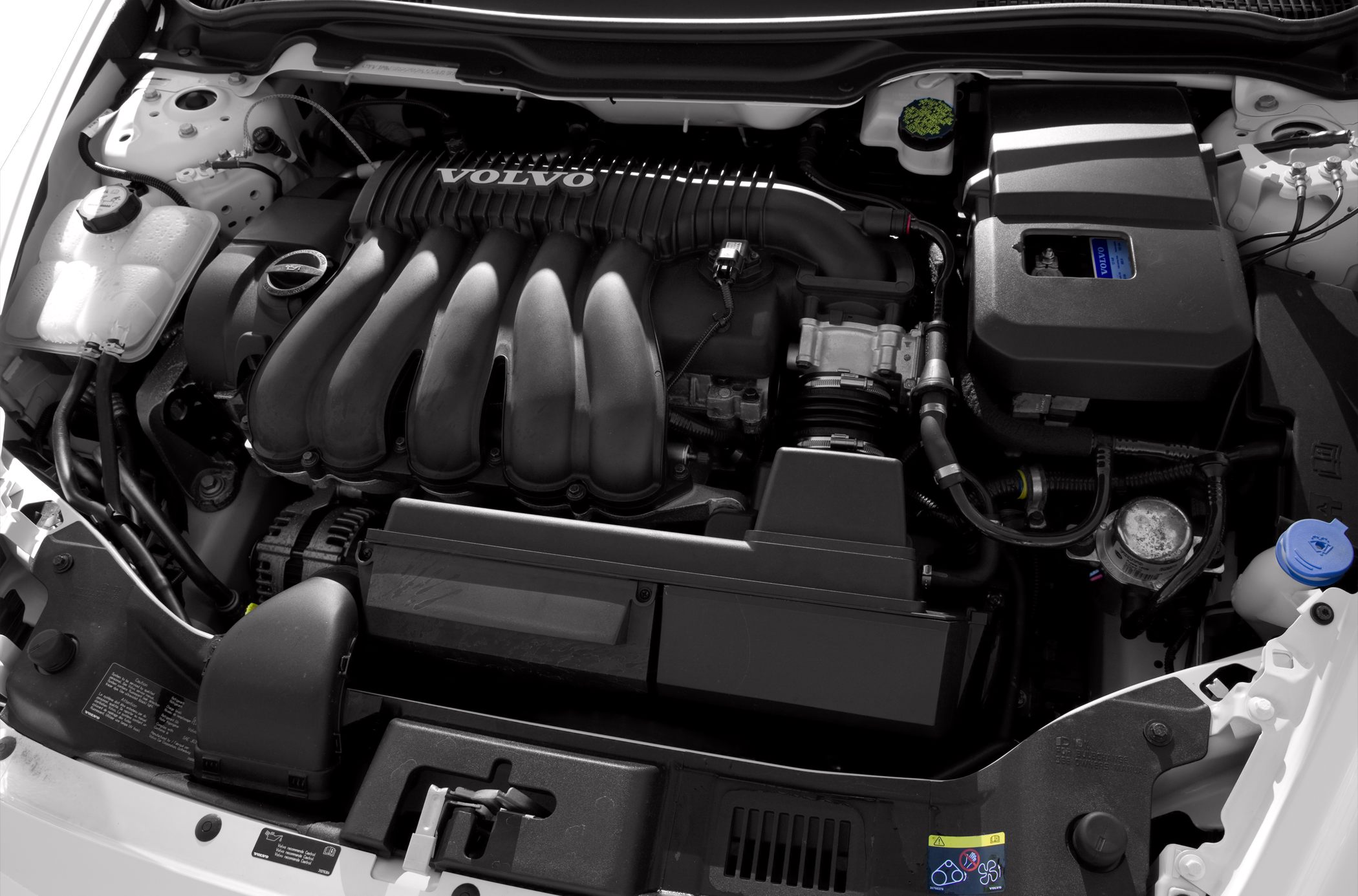 Close-up detailed view of a car engine bay with visible intake manifold and components