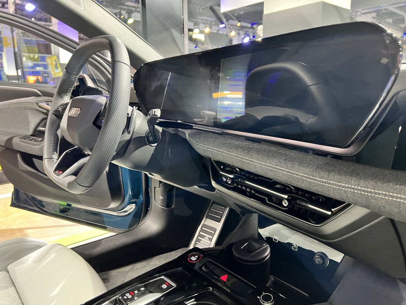 Sleek digital instrument cluster and sporty steering wheel in luxury electric vehicle interior